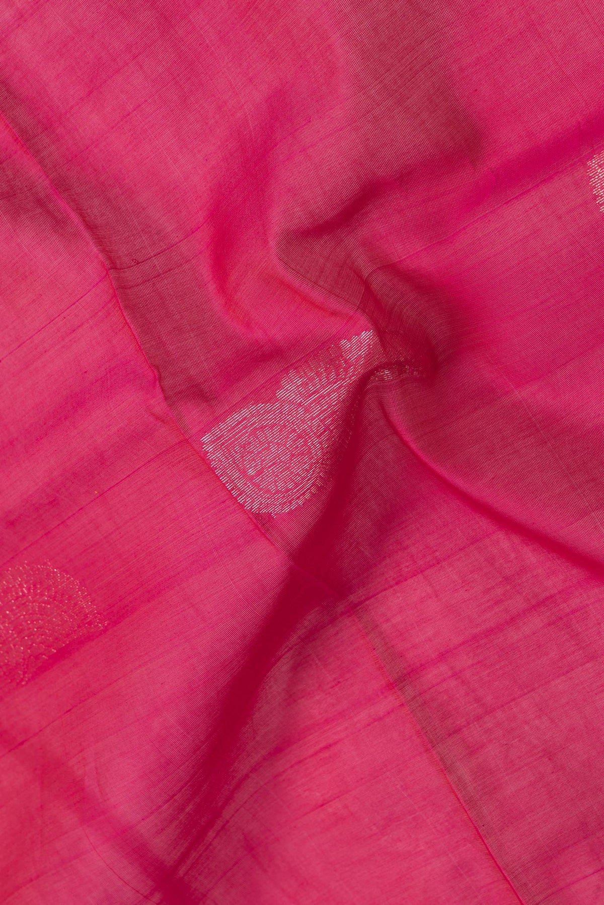 Close up of Dark Pink Dual Tone Silk Cotton Saree with Zari Butta on the body and Zari Border.  displaying folds