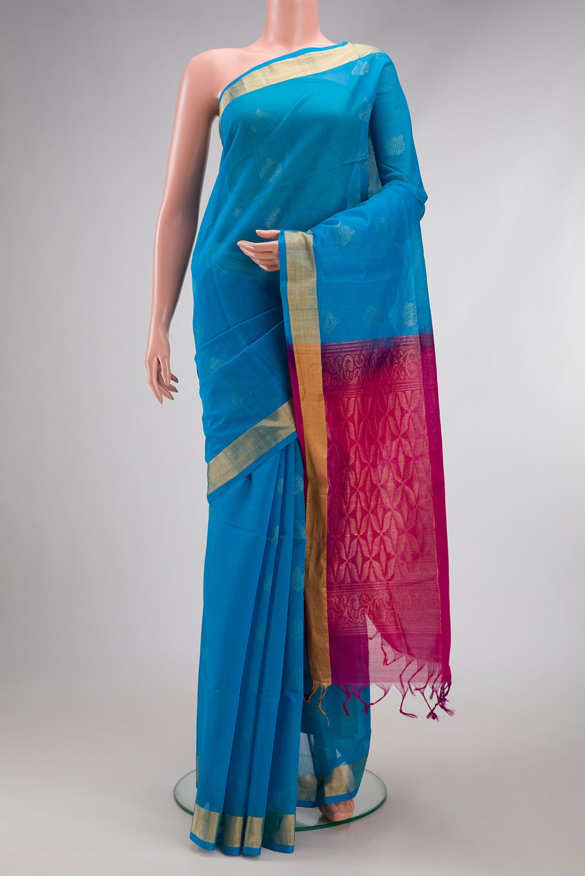 Sky Blue Silk Cotton Saree with Zari Butta on the body and Zari Border.  displayed on a mannequin