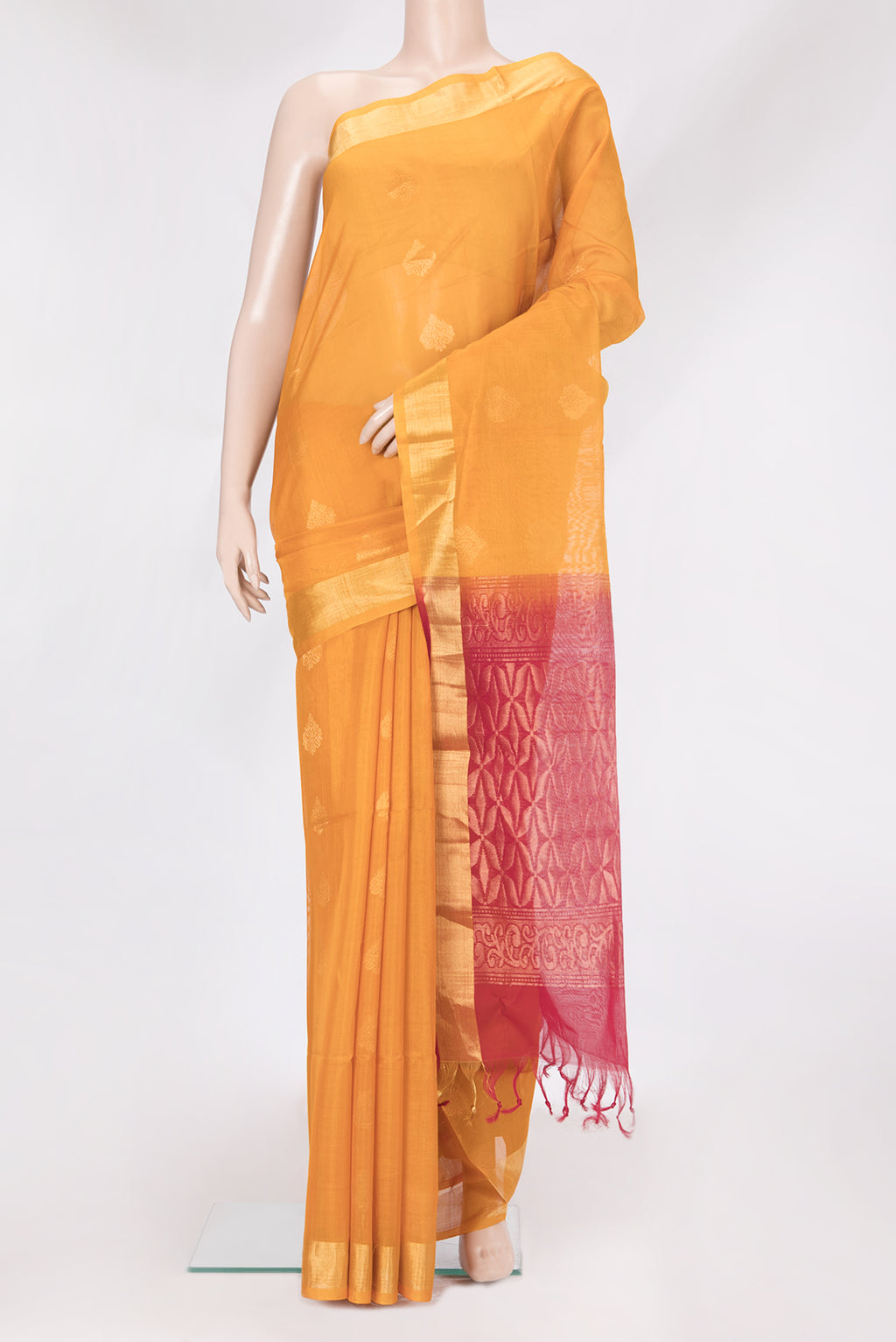 Mustard Silk Cotton Saree with Zari Butta on the body and Zari Border.  displayed on a mannequin