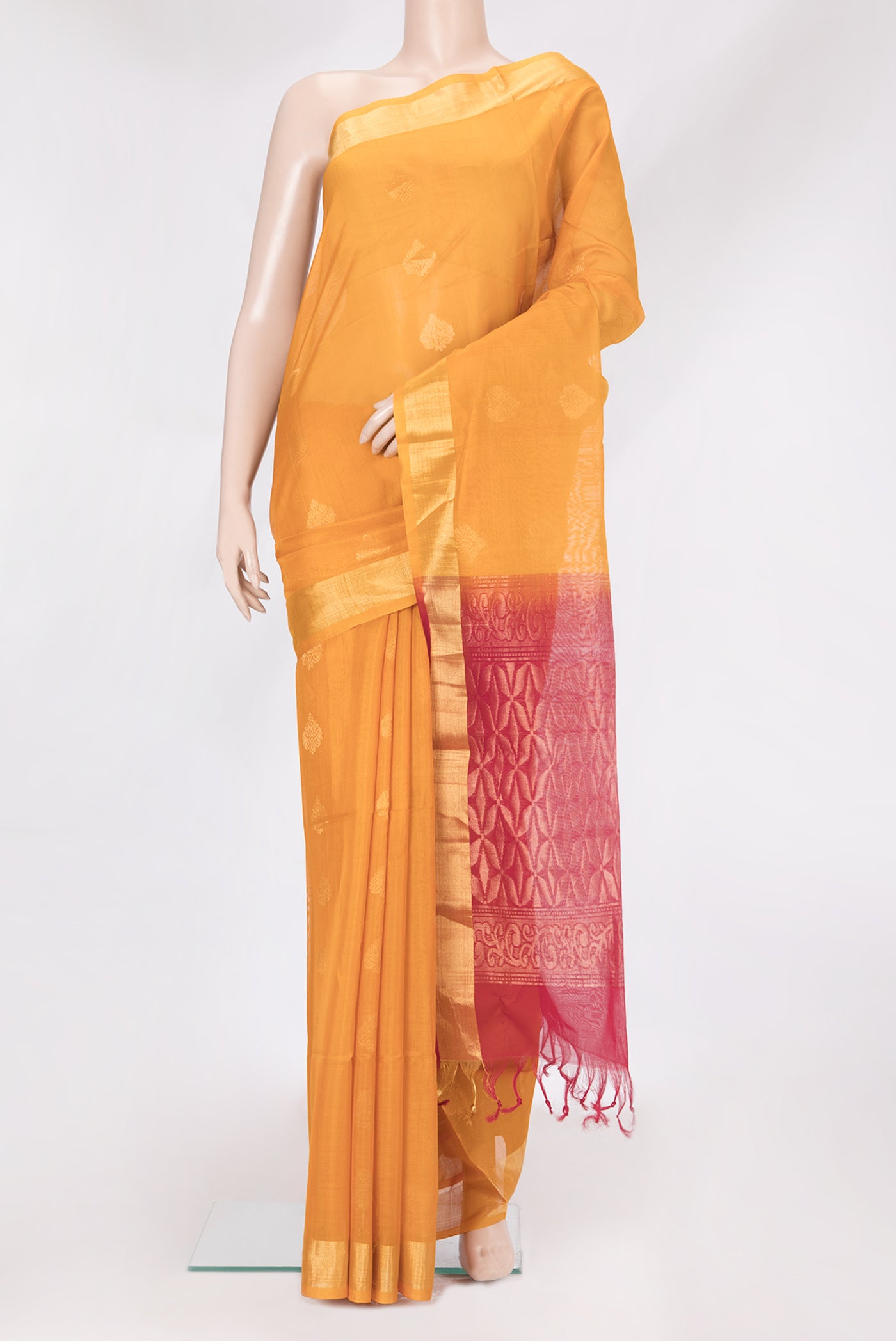 Mustard Silk Cotton Saree with Zari Butta on the body and Zari Border.  displayed on a mannequin