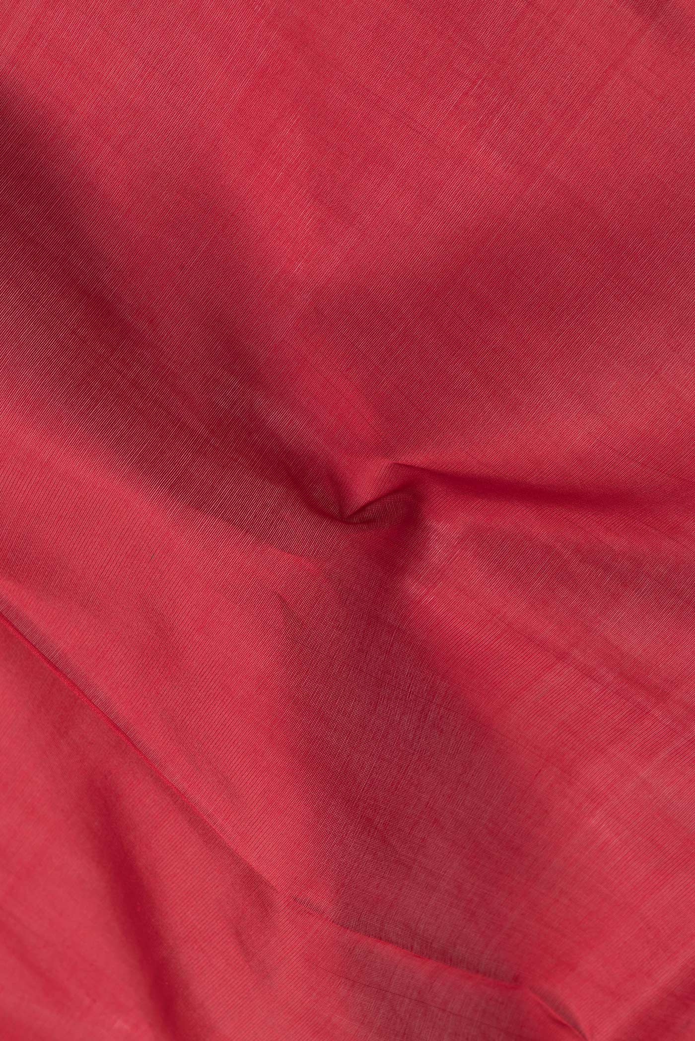 Close up of Red Dual Tone Silk Cotton Saree with Zari Butta on the body and Zari Border.  displaying folds
