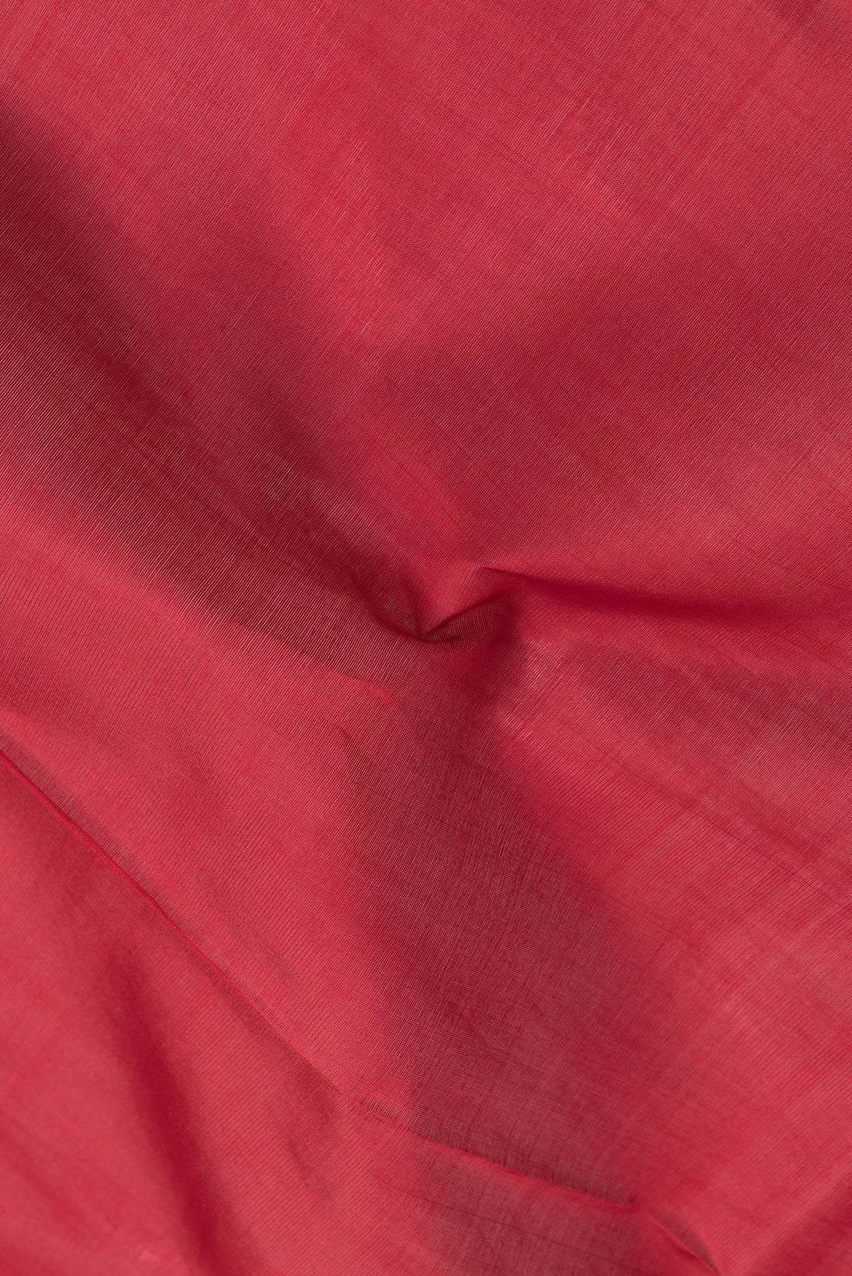 Close up of Red Dual Tone Silk Cotton Saree with Zari Butta on the body and Zari Border.  displaying folds