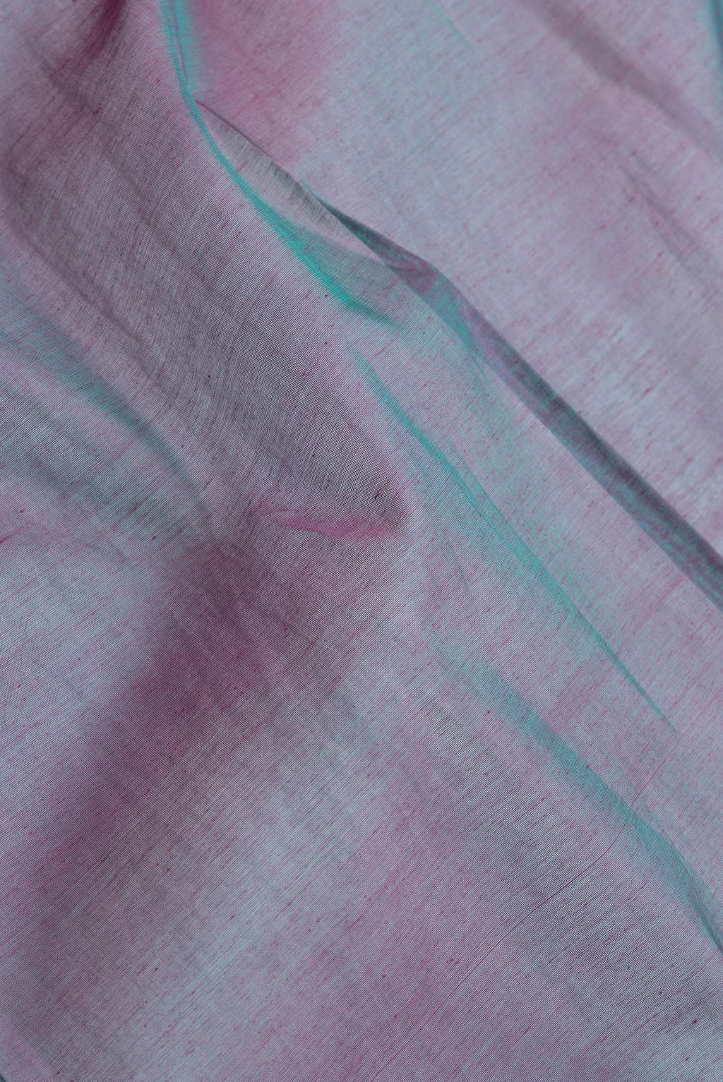 Close up of Peacock Blue Dual Tone Silk Cotton Saree with Zari Butta on the body and Zari Border.  displaying folds