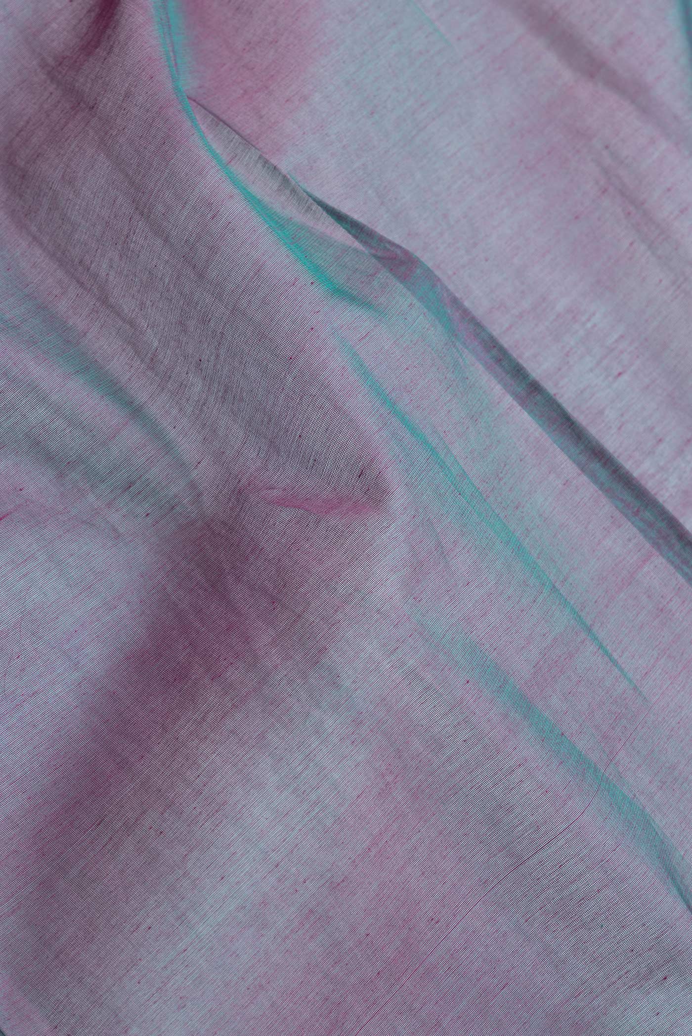 Close up of Peacock Blue Dual Tone Silk Cotton Saree with Zari Butta on the body and Zari Border.  displaying folds