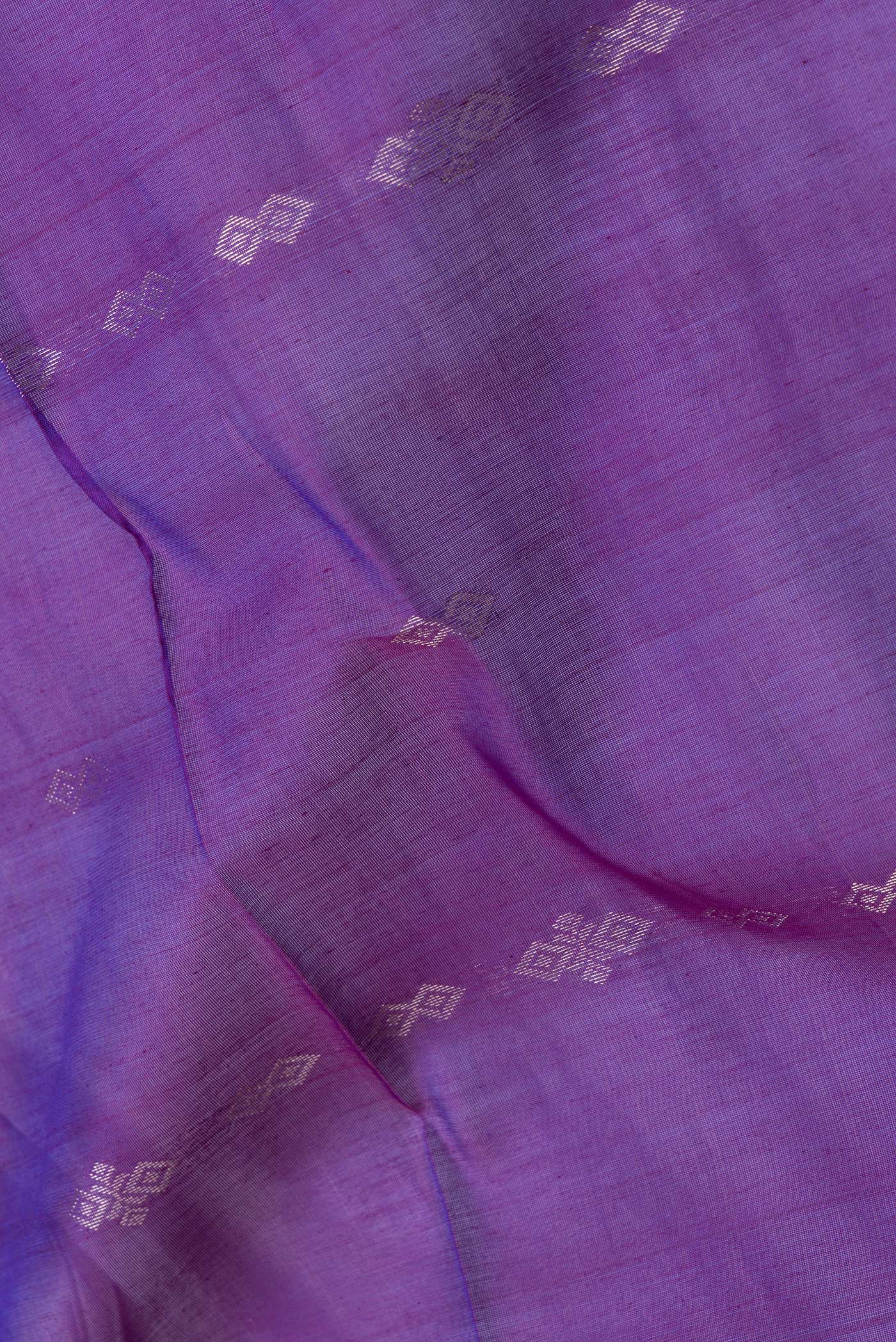 Close up of Purple Dual Tone Silk Cotton Saree with Zari Butta on the body and Zari Border.  displaying folds