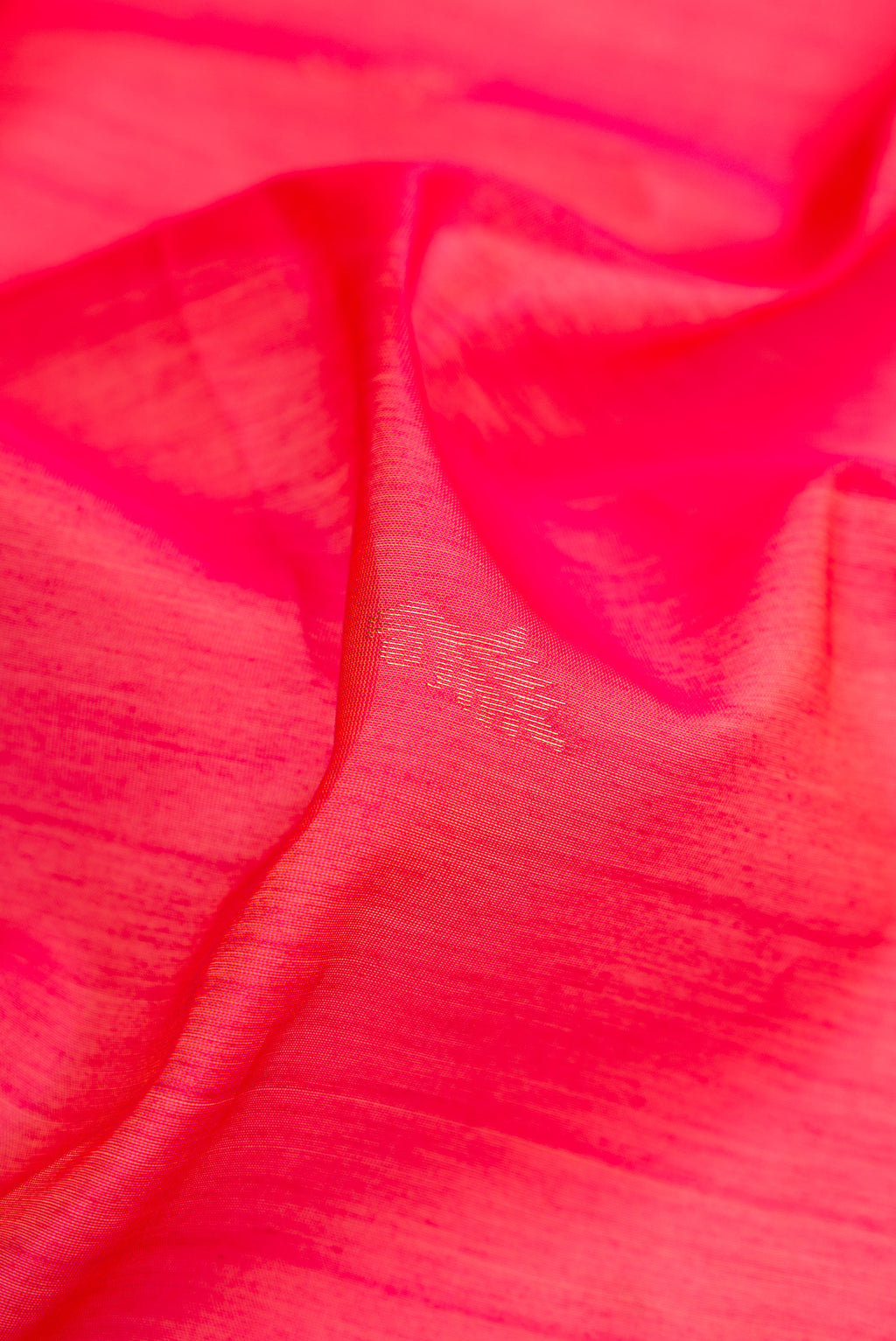 Close up of Pink Silk Cotton Saree with Zari Butta on the body and Zari Border.  displaying folds