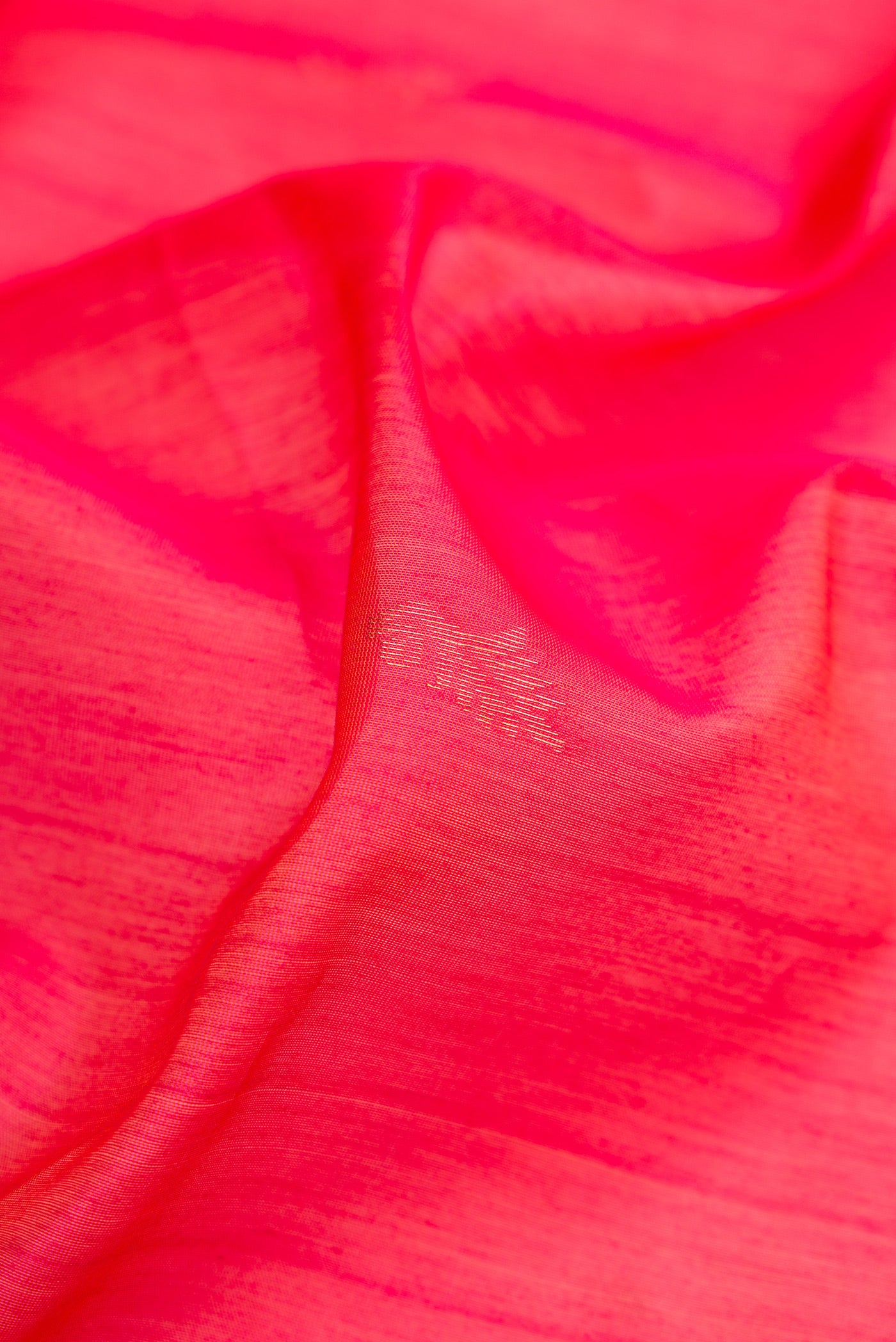 Close up of Pink Silk Cotton Saree with Zari Butta on the body and Zari Border.  displaying folds