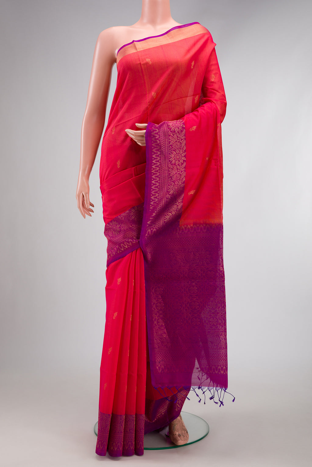 Pink Silk Cotton Saree with Zari Butta on the body and Zari Border.  displayed on a mannequin