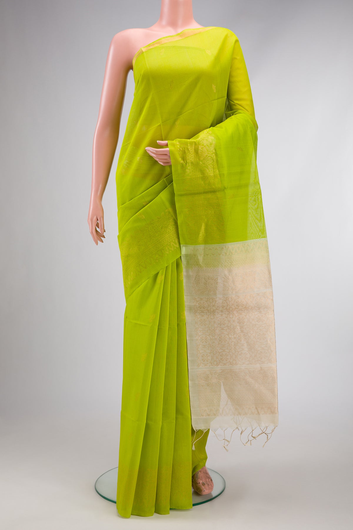 Parrot Green Silk Cotton Saree with Zari Butta on the body and Fancy Border.  displayed on a mannequin