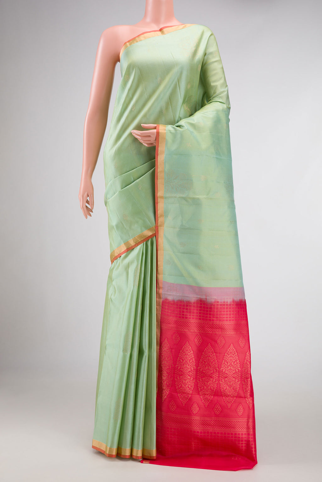 Pista Green Dual Tone Soft Silk Saree with Zari Butta on the body and Zari Border.  displayed on a mannequin