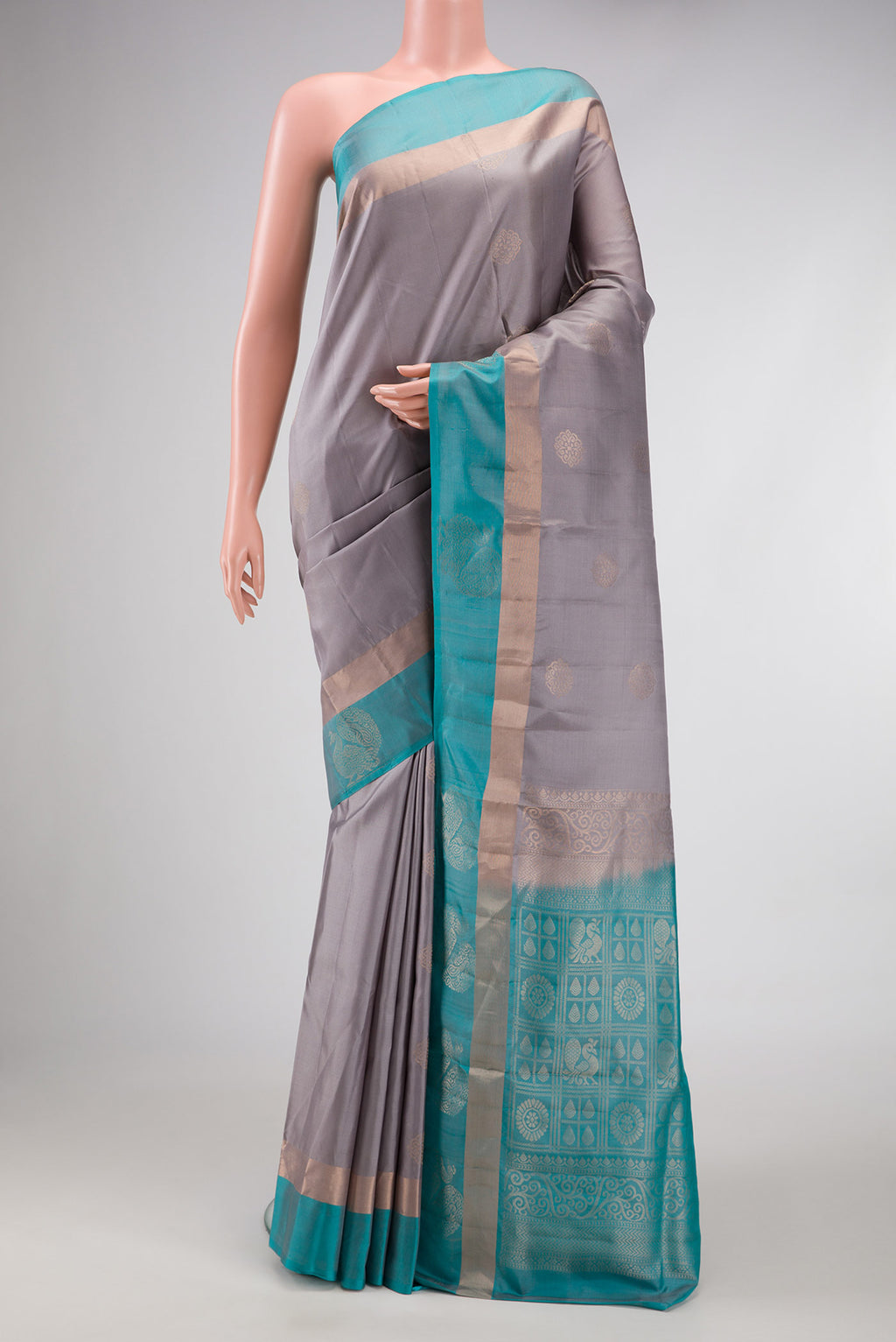 Grey Dual Tone Soft Silk Saree with Zari Butta on the body and Fancy Border.  displayed on a mannequin