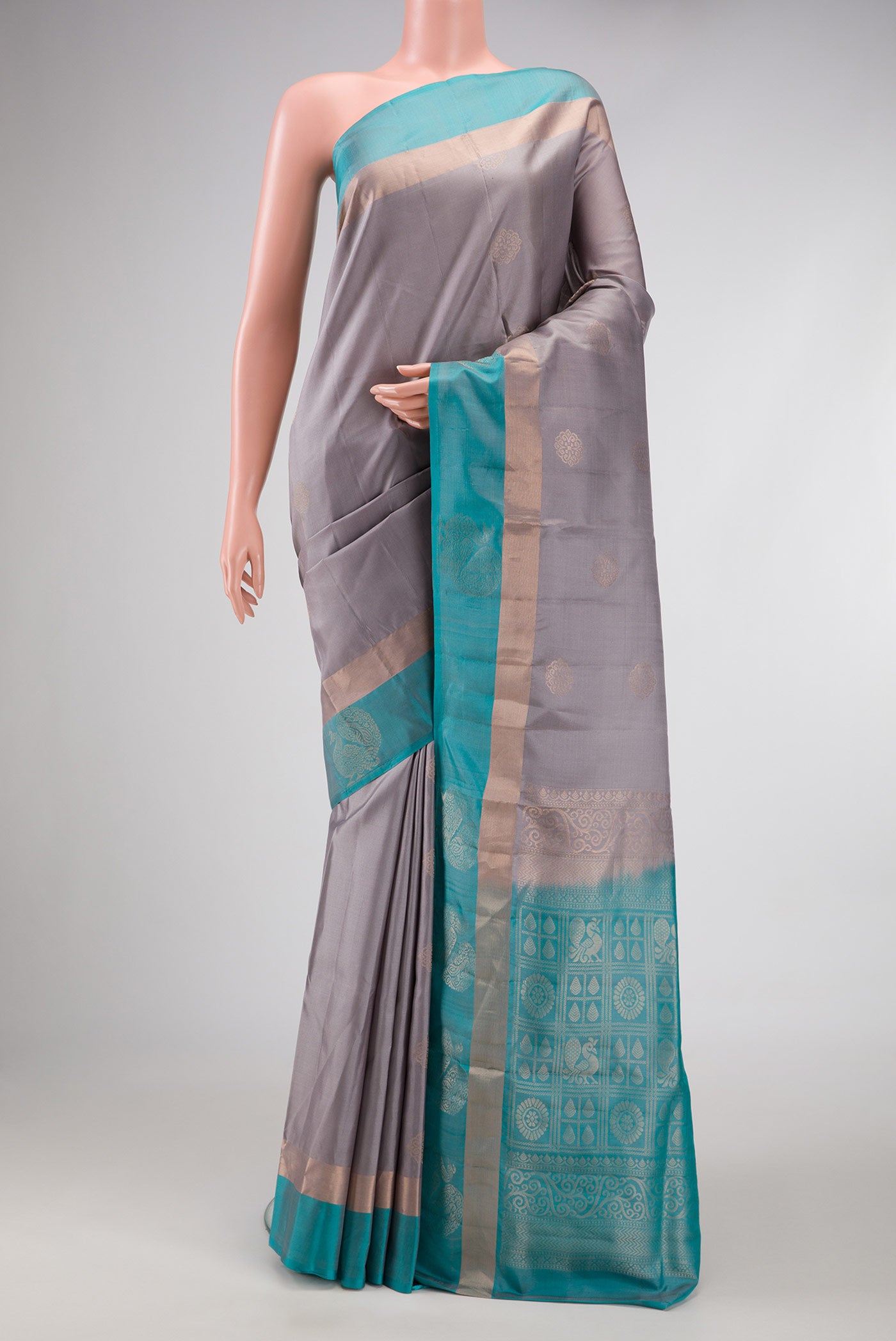 Grey Dual Tone Soft Silk Saree with Zari Butta on the body and Fancy Border.  displayed on a mannequin