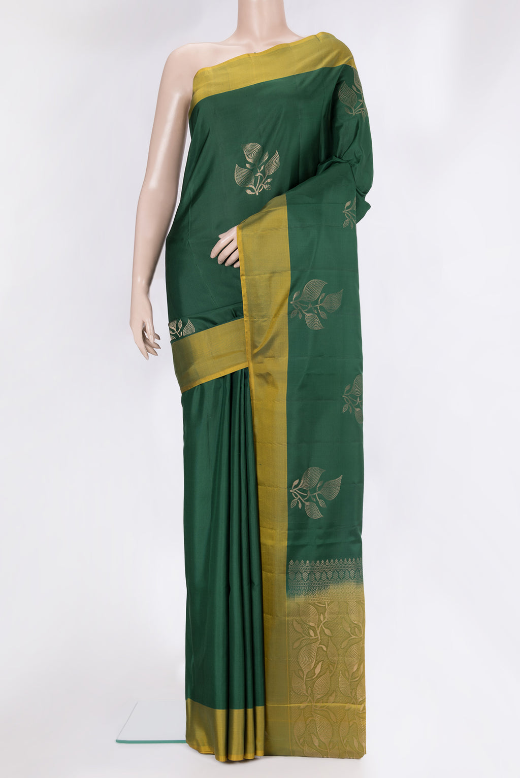Bottle Green Soft Silk Saree with Zari Butta on the body and Plain Border.  displayed on a mannequin