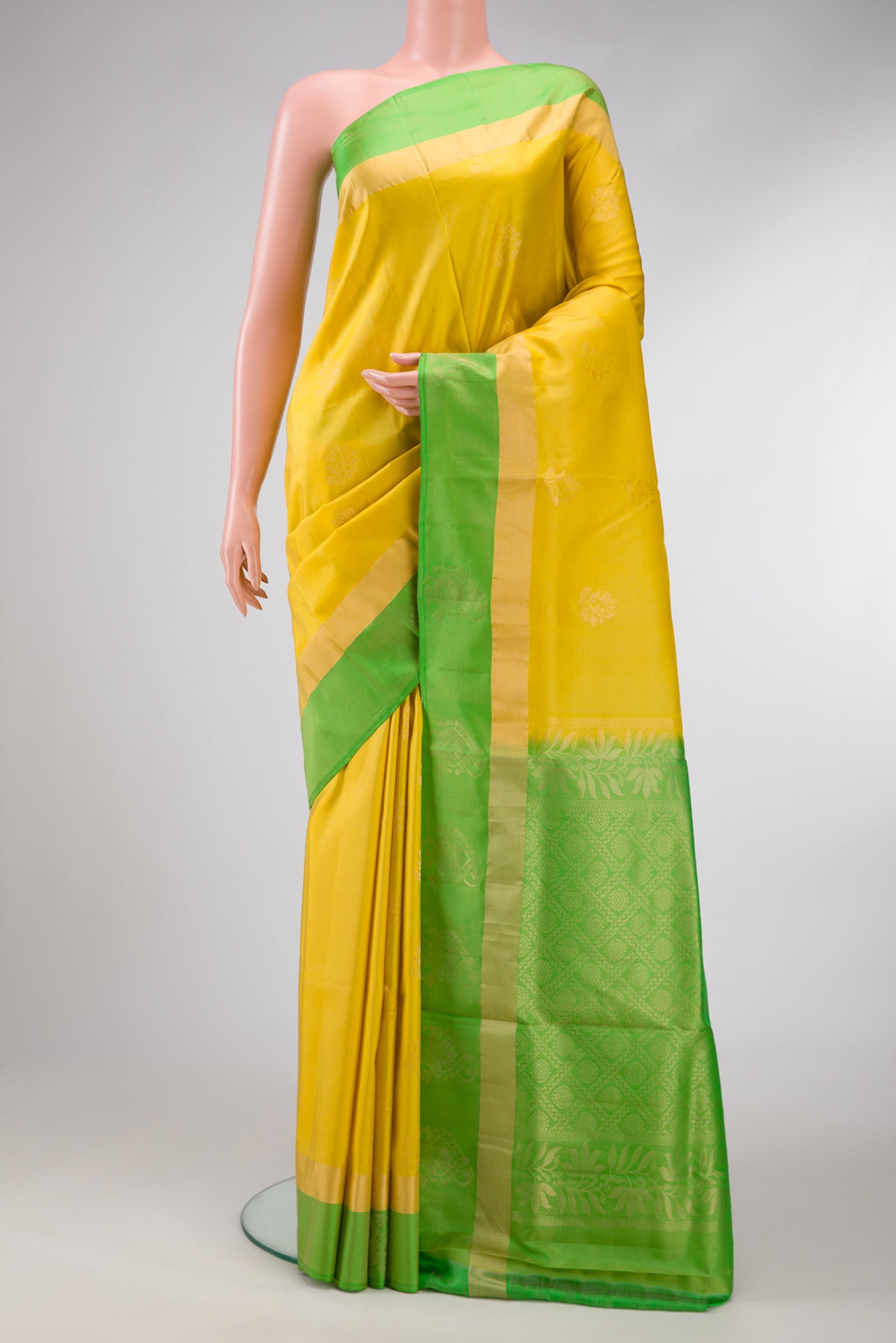 Mustard Dual Tone Soft Silk Saree with Zari Butta on the body and Zari Border.  displayed on a mannequin