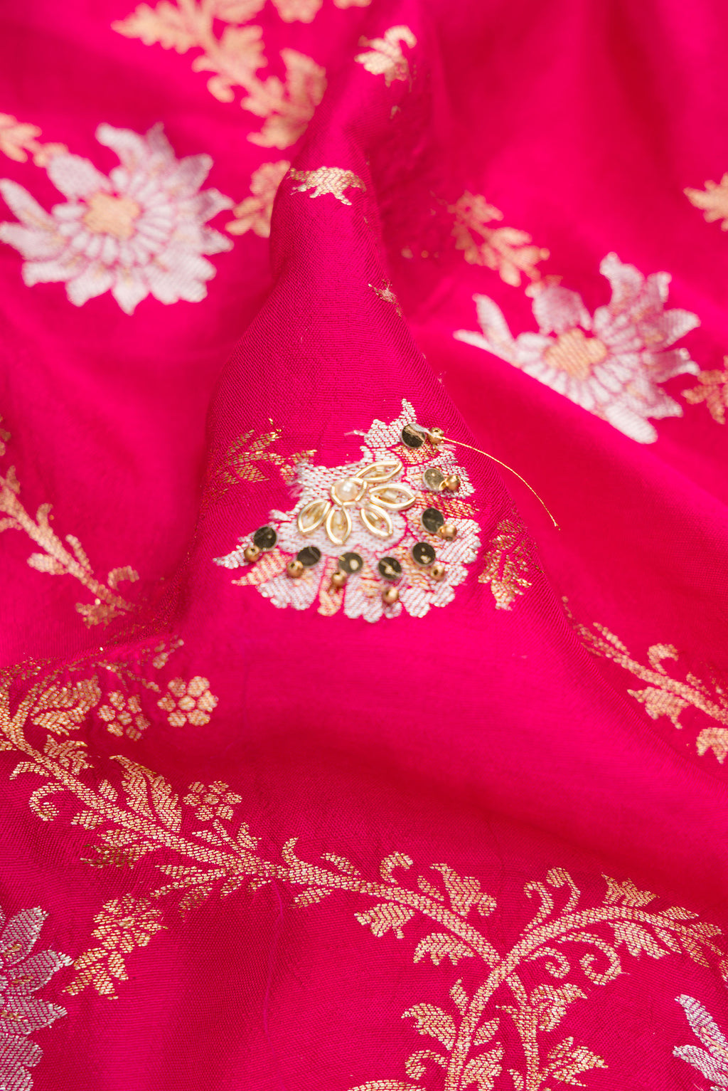 Close up of Pink Dual Tone Georgette Saree with Zari Brocade on the body and Embroidery Border.  displaying folds