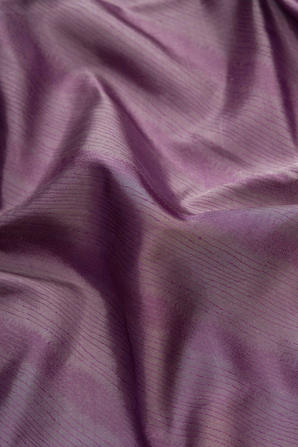 Close up of Burgundy Dual Tone Kanchipuram Silk Saree with Jacquard design on the body and Temple Border.  displaying folds