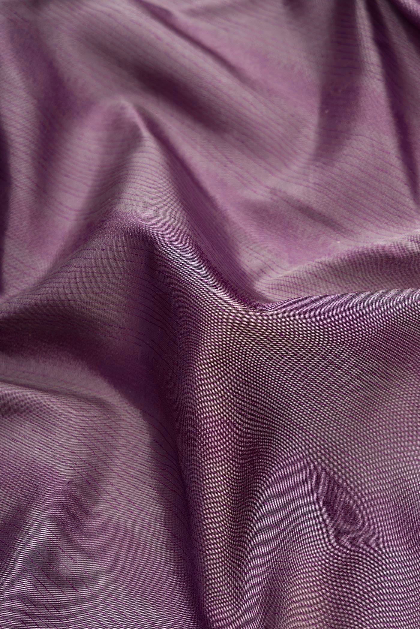 Close up of Burgundy Dual Tone Kanchipuram Silk Saree with Jacquard design on the body and Temple Border.  displaying folds