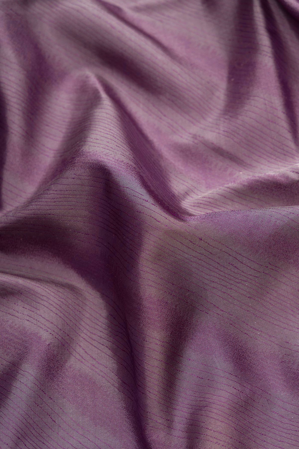 Close up of Burgundy Dual Tone Kanchipuram Silk Saree with Jacquard design on the body and Temple Border.  displaying folds