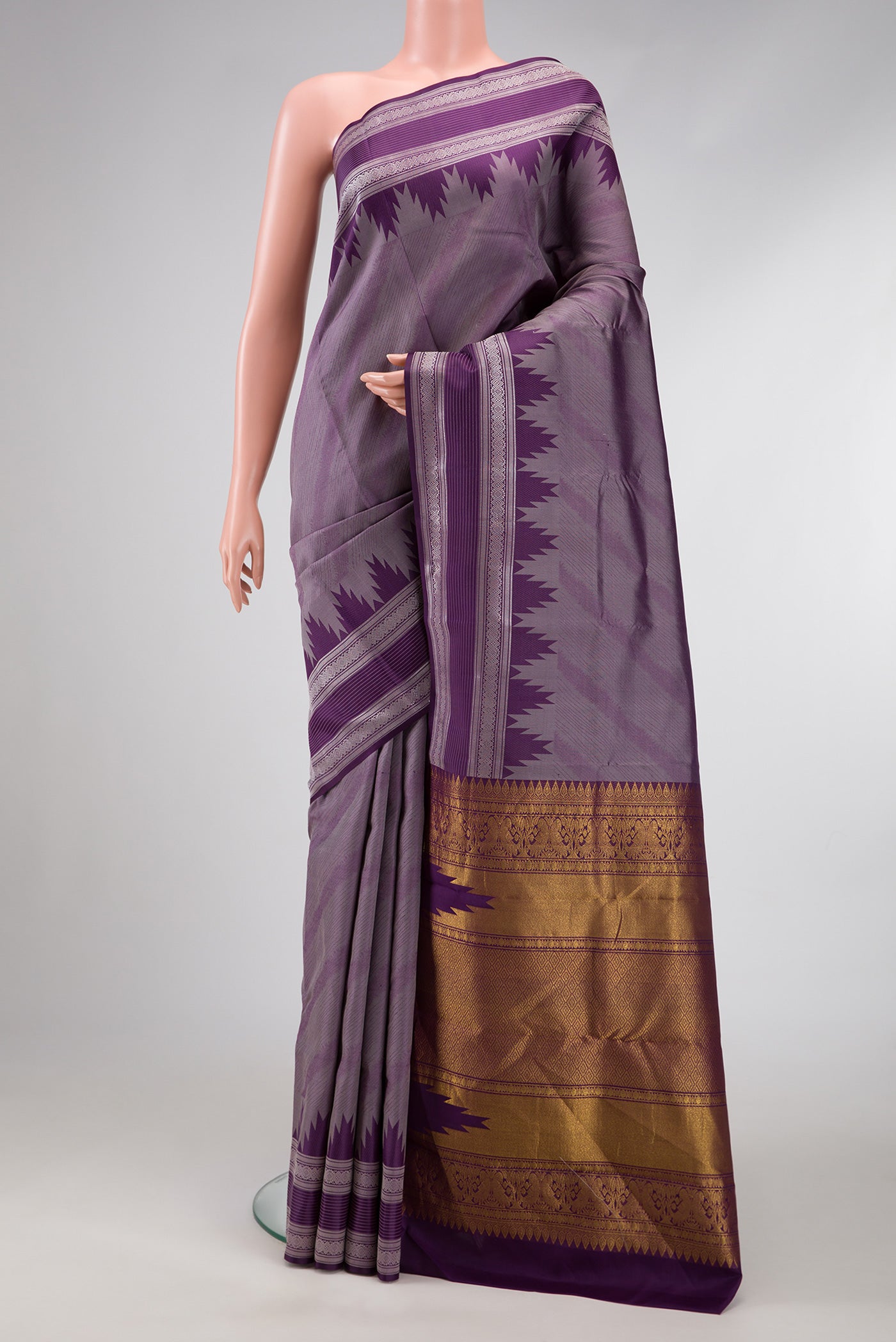 Burgundy Dual Tone Kanchipuram Silk Saree with Jacquard design on the body and Temple Border.  displayed on a mannequin