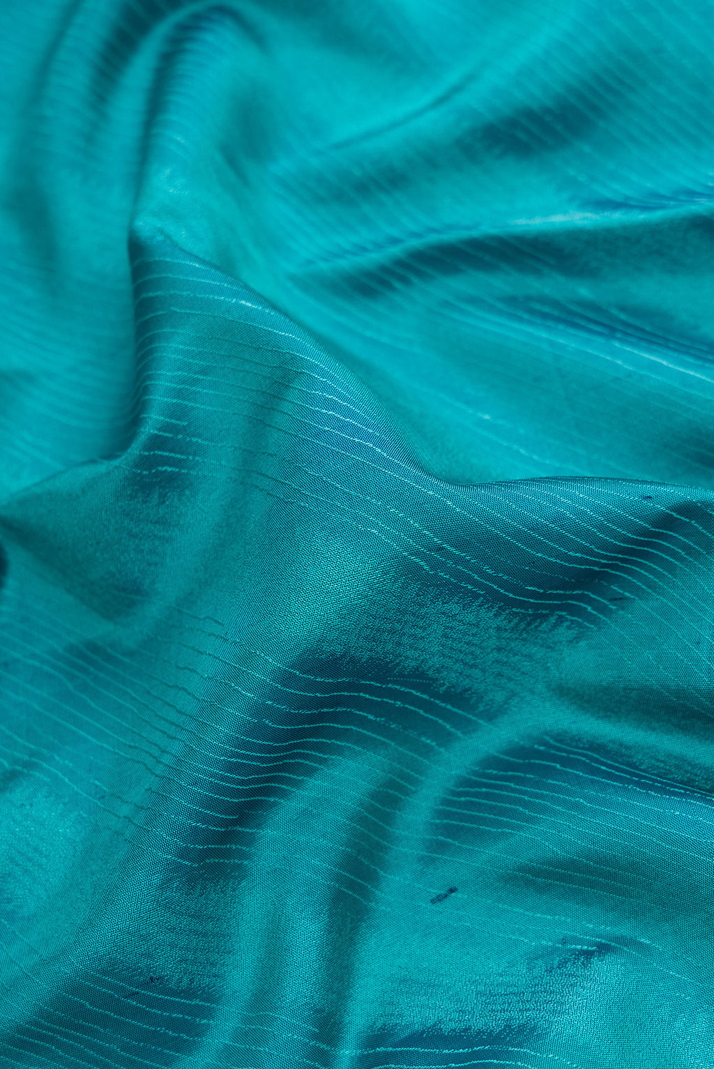 Close up of Sky Blue Dual Tone Kanchipuram Silk Saree with Jacquard design on the body and Temple Border.  displaying folds