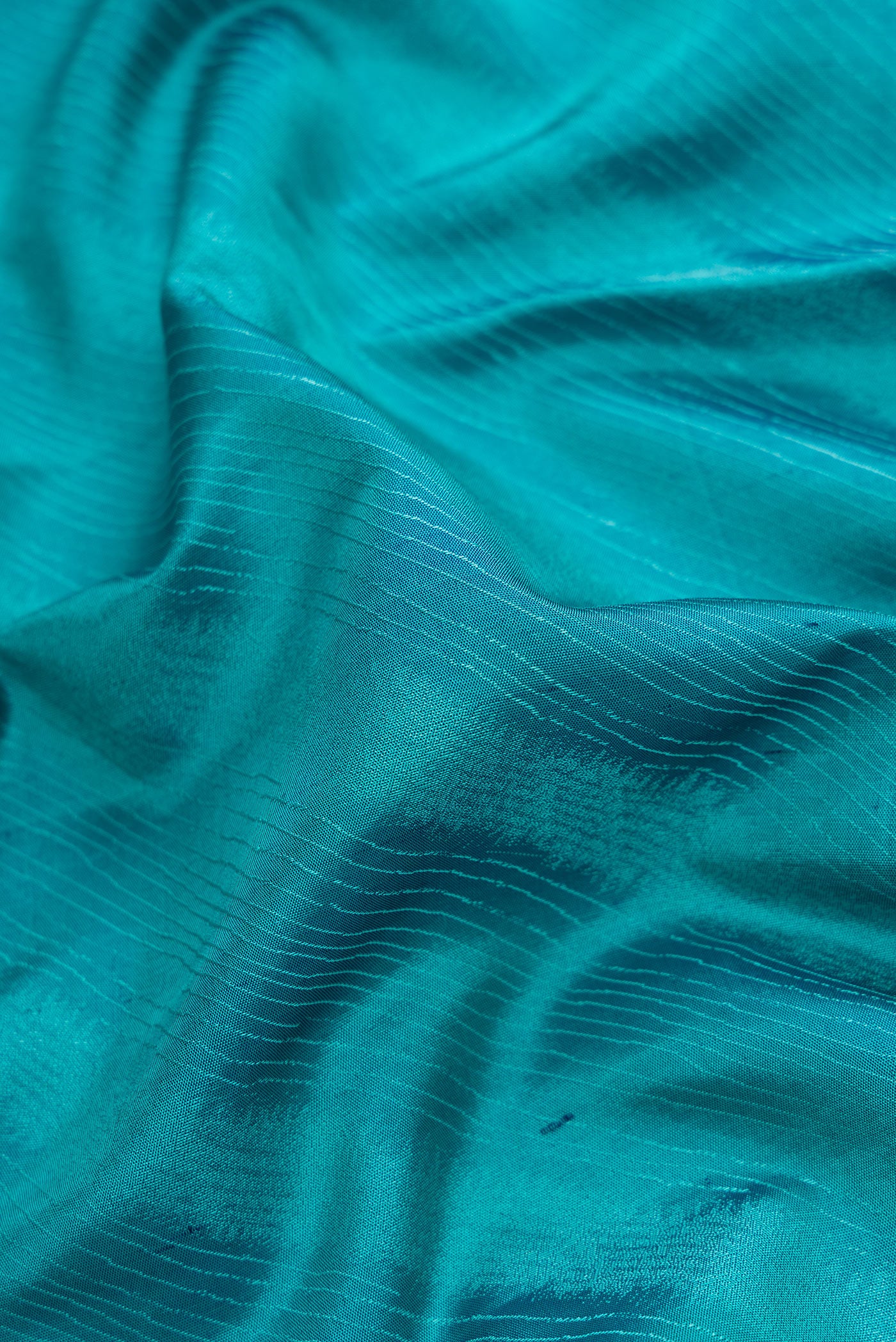 Close up of Sky Blue Dual Tone Kanchipuram Silk Saree with Jacquard design on the body and Temple Border.  displaying folds