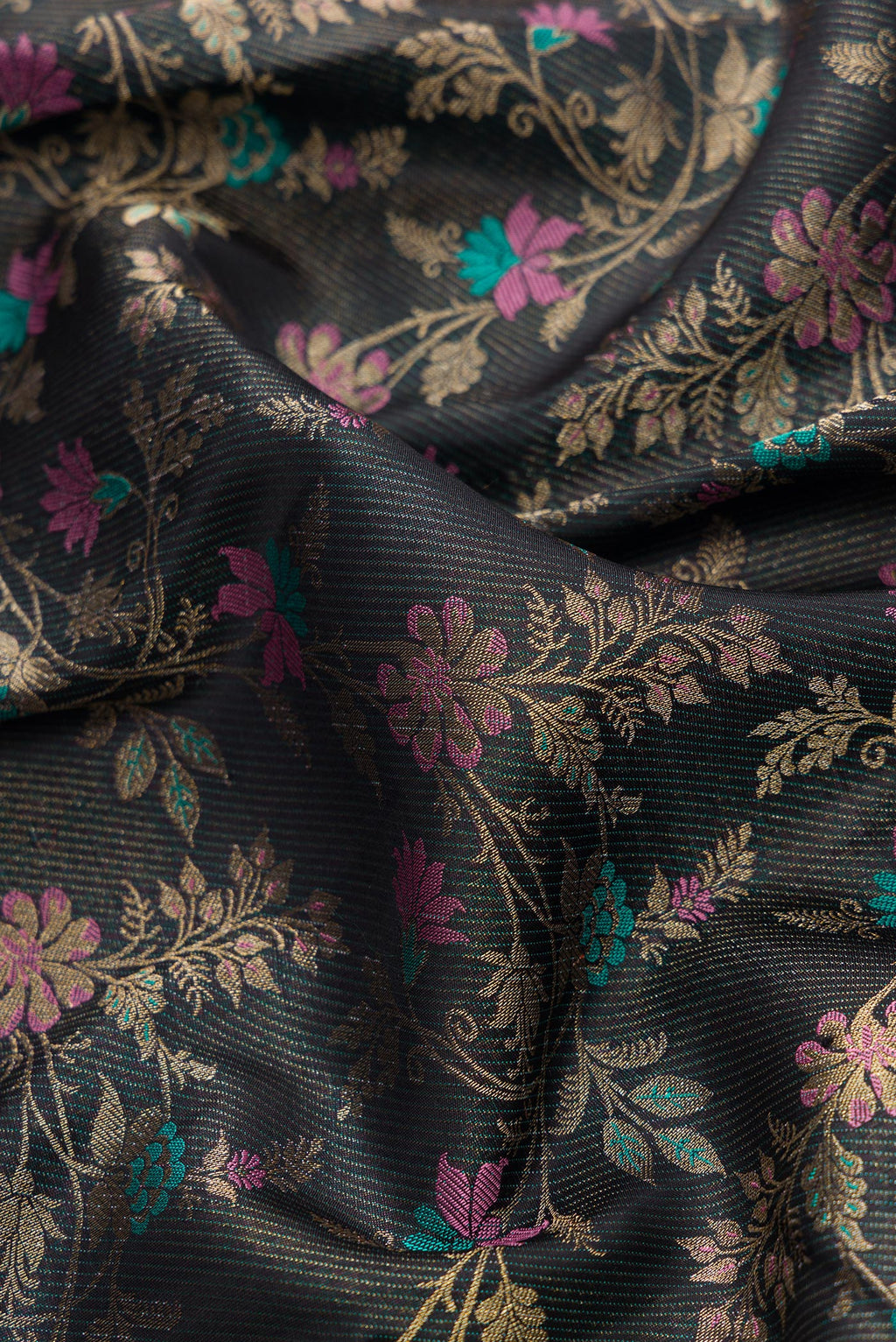 Close up of Black Dual Tone Kanchipuram Silk Saree with Zari Brocade on the body and Fancy Border.  displaying folds
