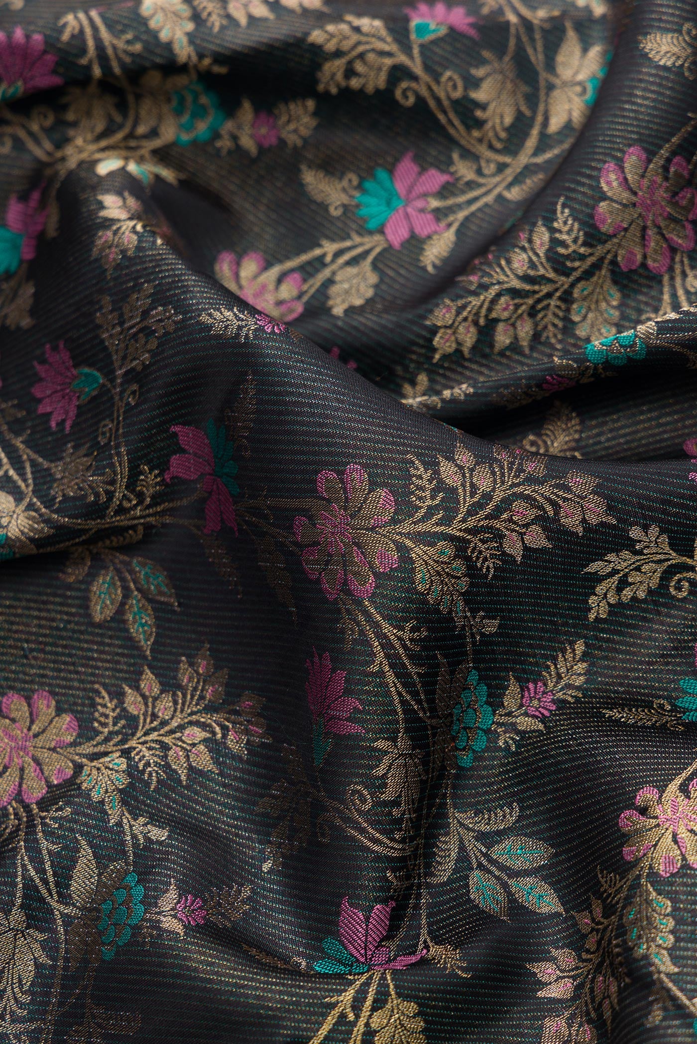 Close up of Black Dual Tone Kanchipuram Silk Saree with Zari Brocade on the body and Fancy Border.  displaying folds