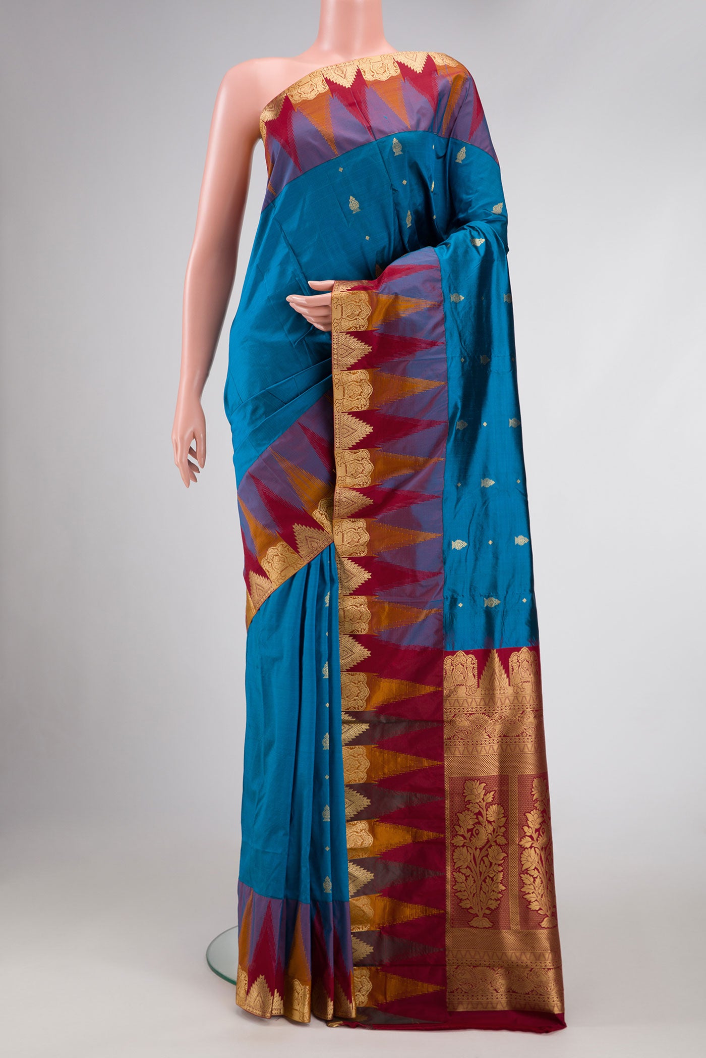 Peacock Blue Dual Tone Kanchipuram Silk Saree with Zari Butta on the body and Temple Border.  displayed on a mannequin