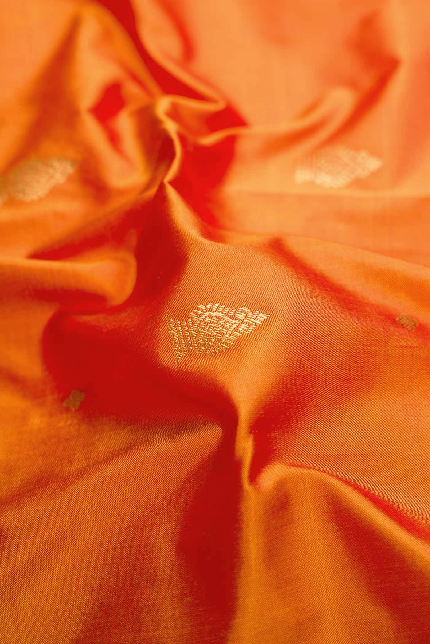 Close up of Mustard Dual Tone Kanchipuram Silk Saree with Zari Butta on the body and Temple Border.  displaying folds