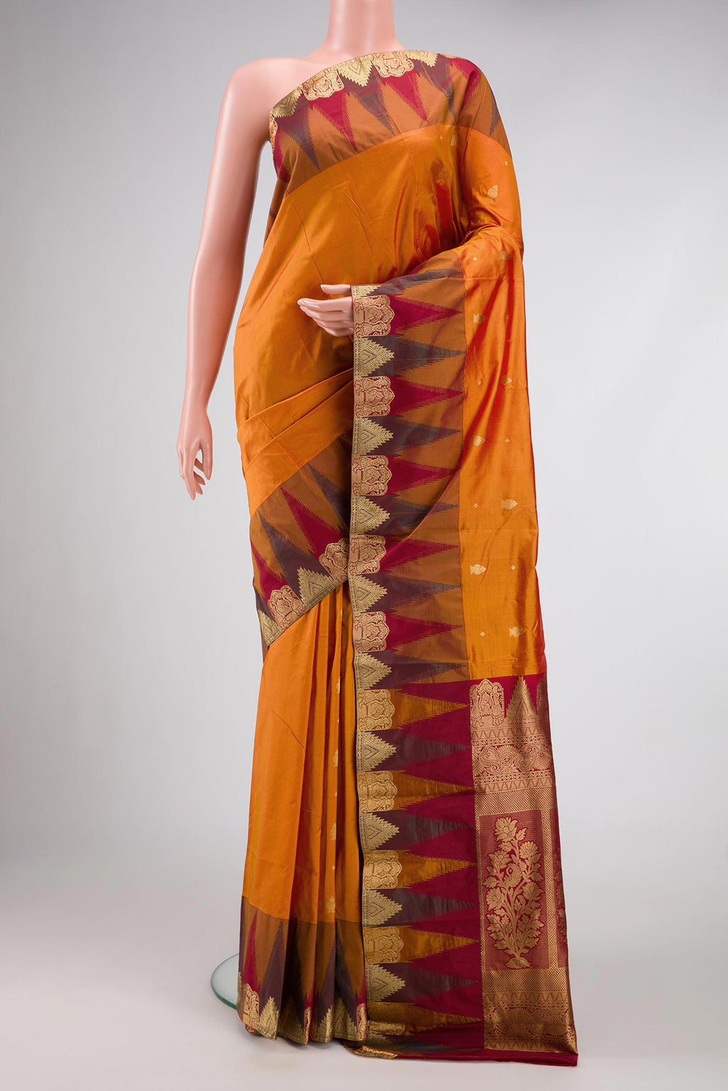 Mustard Dual Tone Kanchipuram Silk Saree with Zari Butta on the body and Temple Border.  displayed on a mannequin