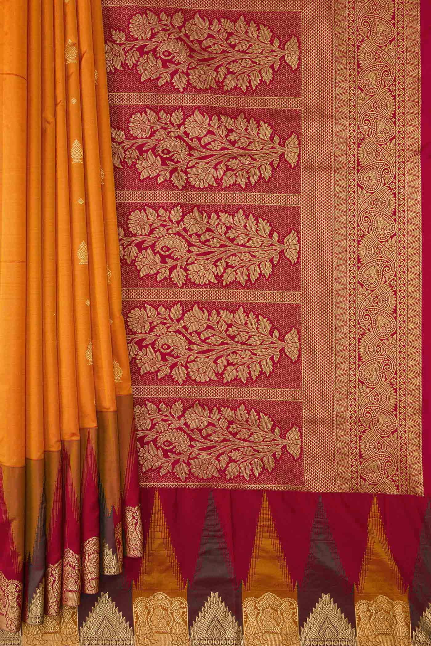 Pleats and pallu of Mustard Dual Tone Kanchipuram Silk Saree with Zari Butta on the body and Temple Border. 