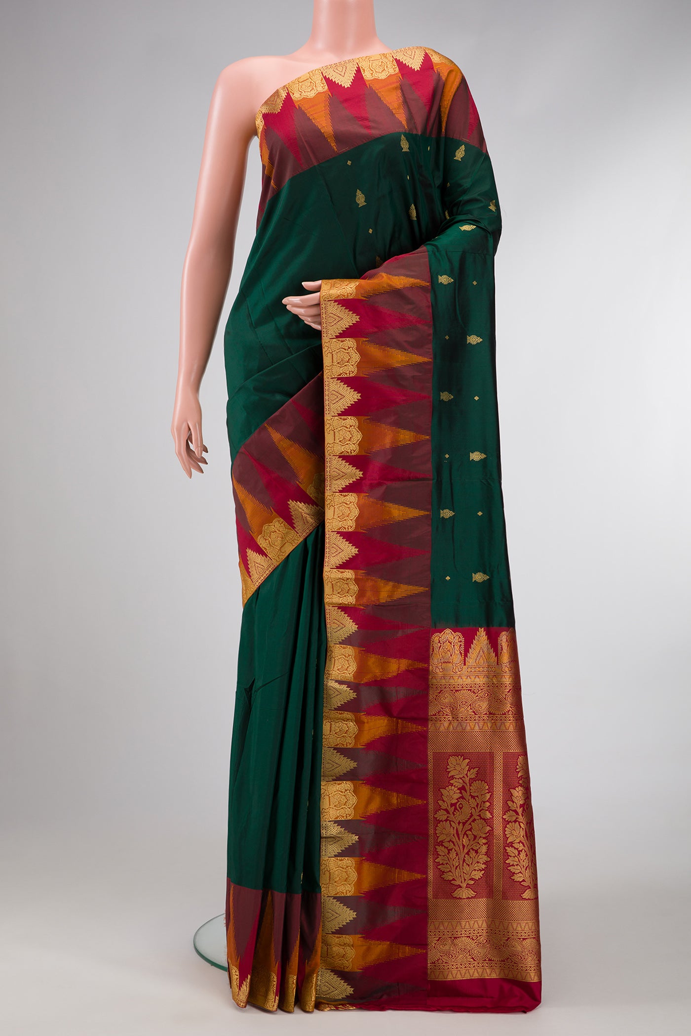 Bottle Green Dual Tone Kanchipuram Silk Saree with Zari Butta on the body and Temple Border.  displayed on a mannequin
