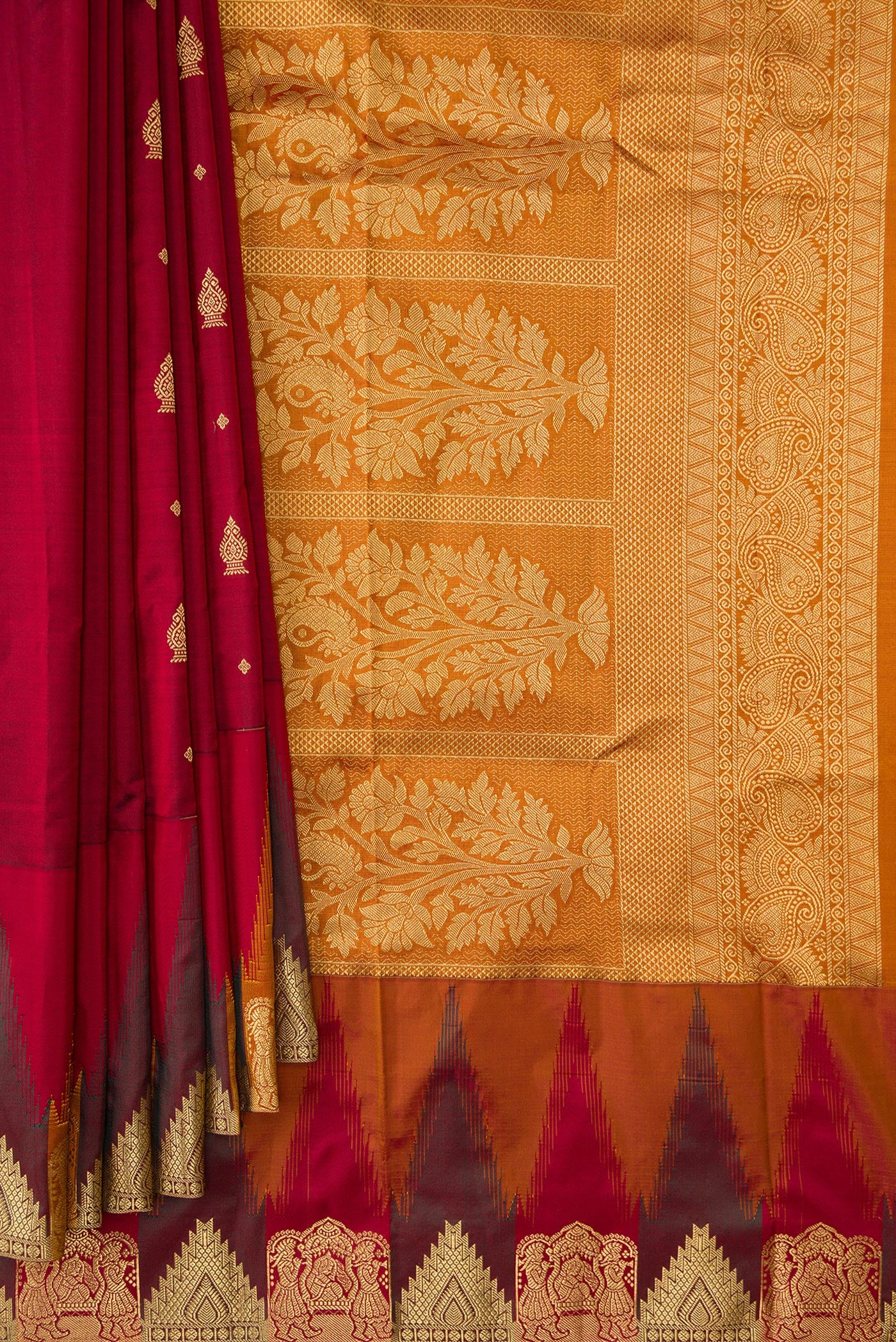 Pleats and pallu of Maroon Dual Tone Kanchipuram Silk Saree with Zari Butta on the body and Temple Border. 