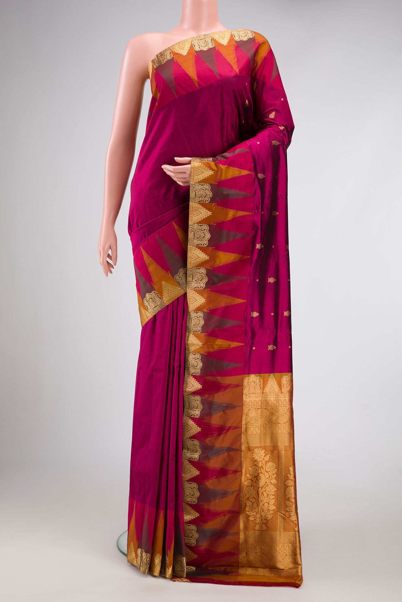 Magenta Dual Tone Kanchipuram Silk Saree with Zari Butta on the body and Temple Border.  displayed on a mannequin