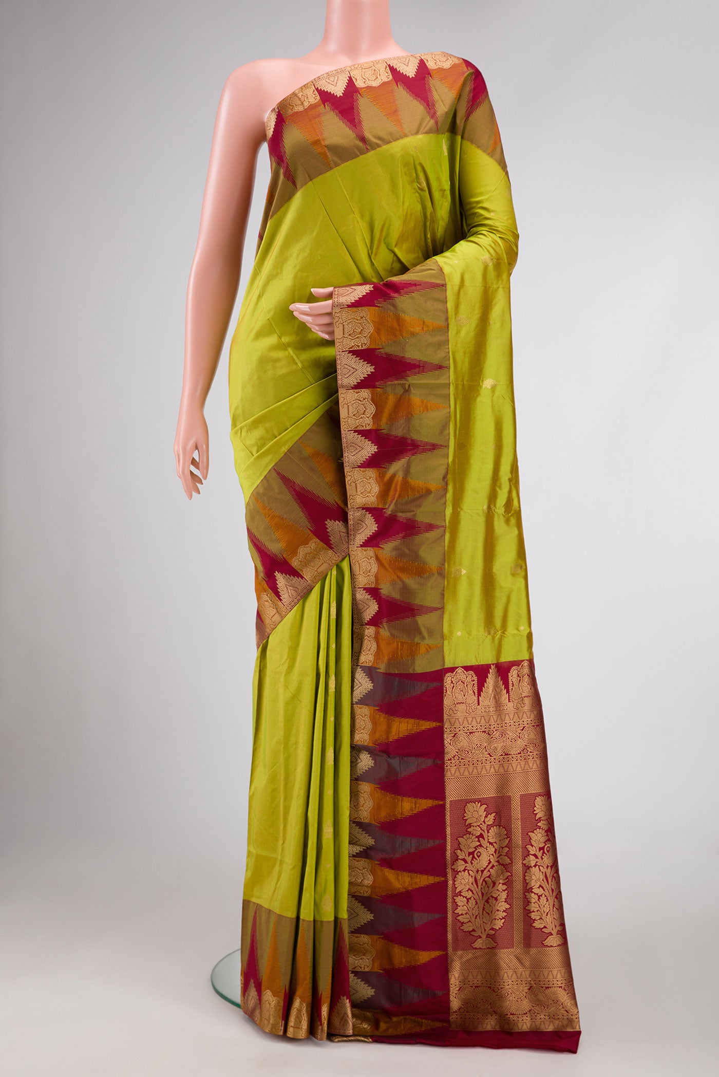 Parrot Green Dual Tone Kanchipuram Silk Saree with Zari Butta on the body and Temple Border.  displayed on a mannequin
