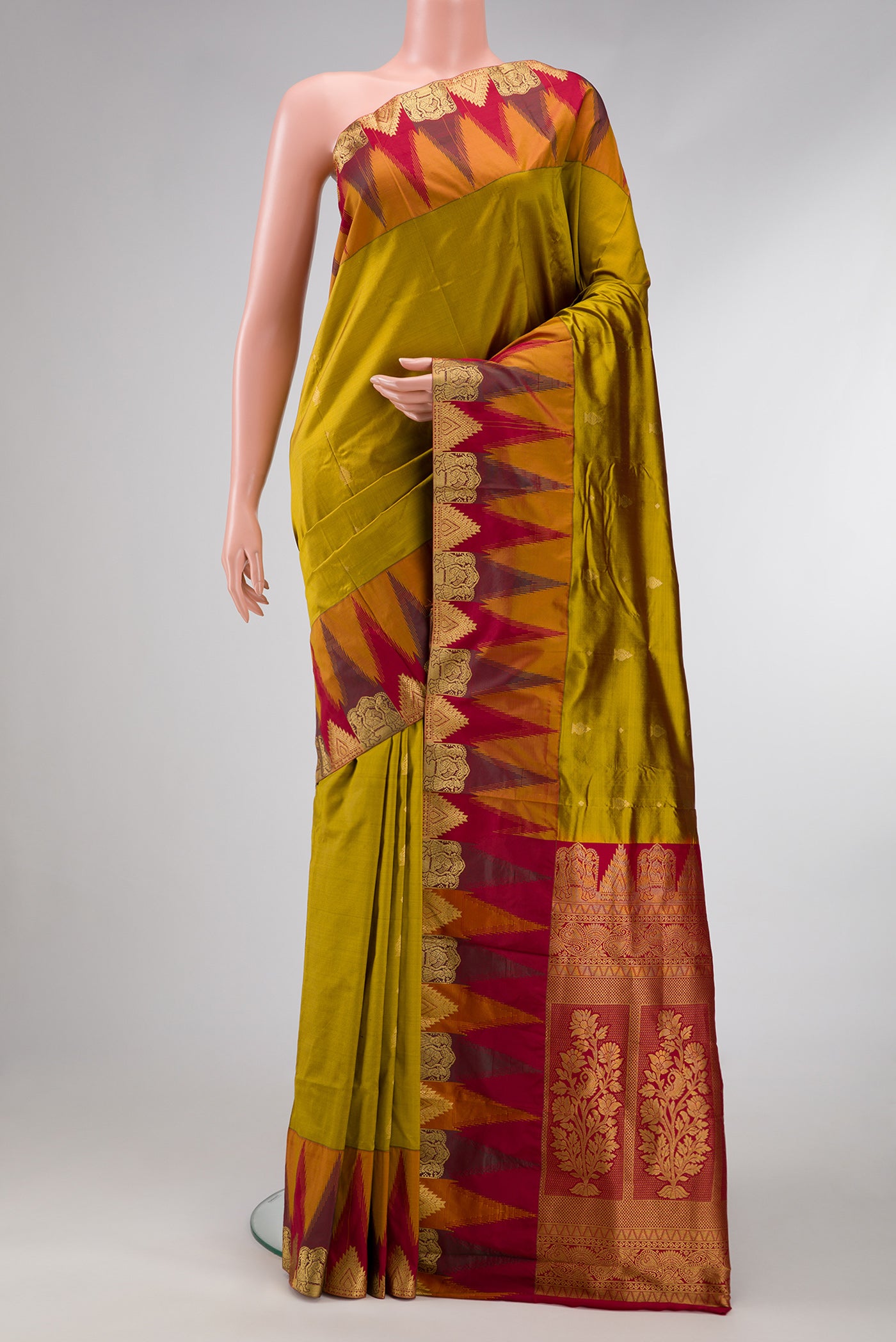 Mehandi Green Dual Tone Kanchipuram Silk Saree with Zari Butta on the body and Temple Border.  displayed on a mannequin