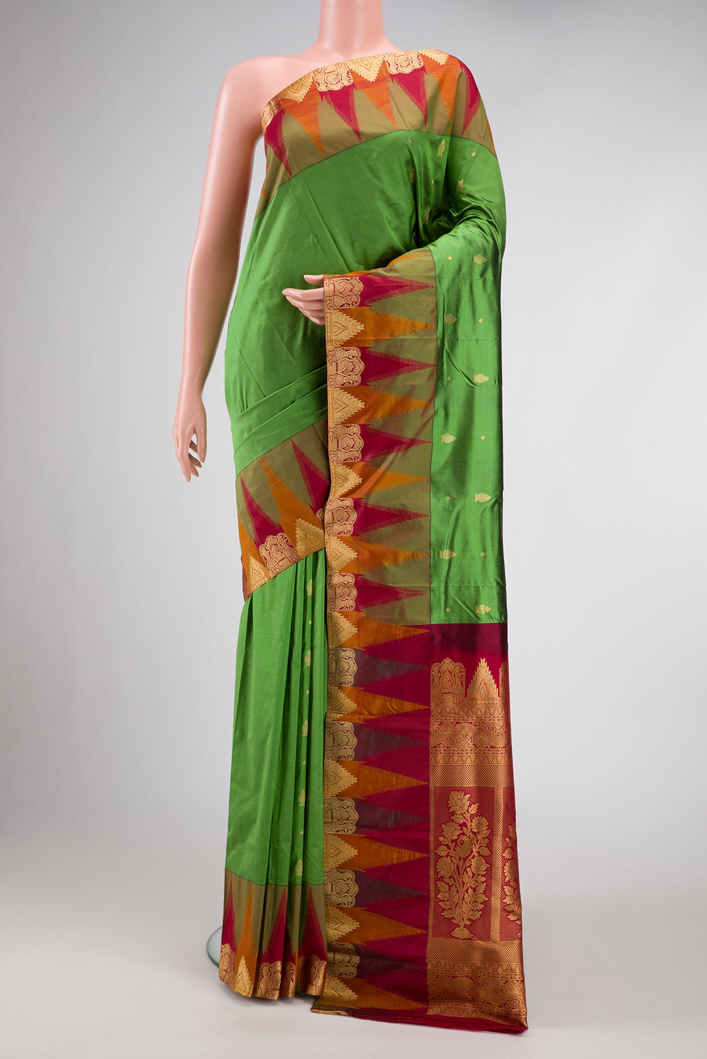 Green Dual Tone Kanchipuram Silk Saree with Zari Butta on the body and Temple Border.  displayed on a mannequin