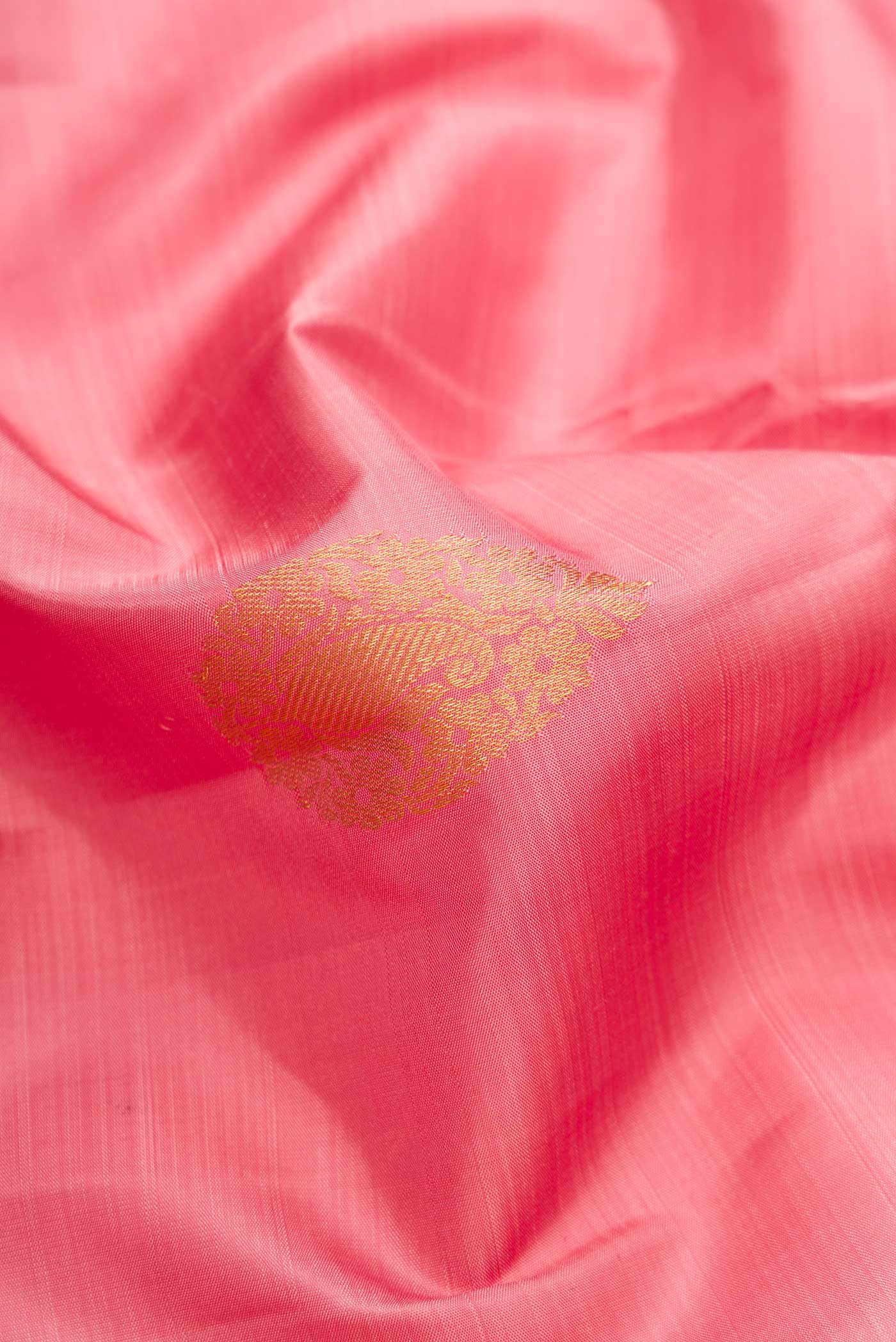Close up of Pink Dual Tone Kanjivaram Silk Saree with Zari Butta on the body and Zari Border.  displaying folds