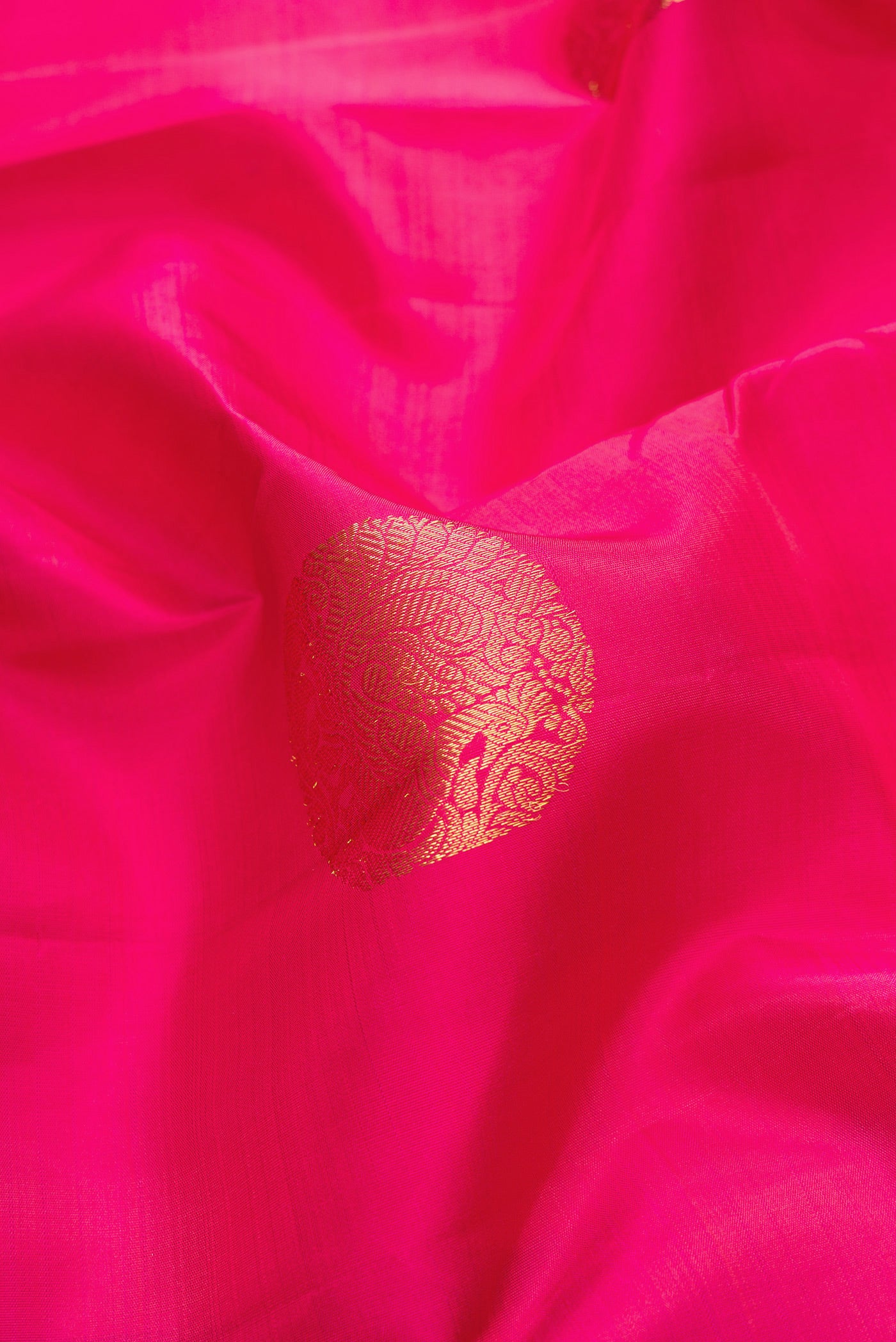 Close up of Pink Dual Tone Kanjivaram Silk Saree with Zari Butta on the body and Zari Border.  displaying folds