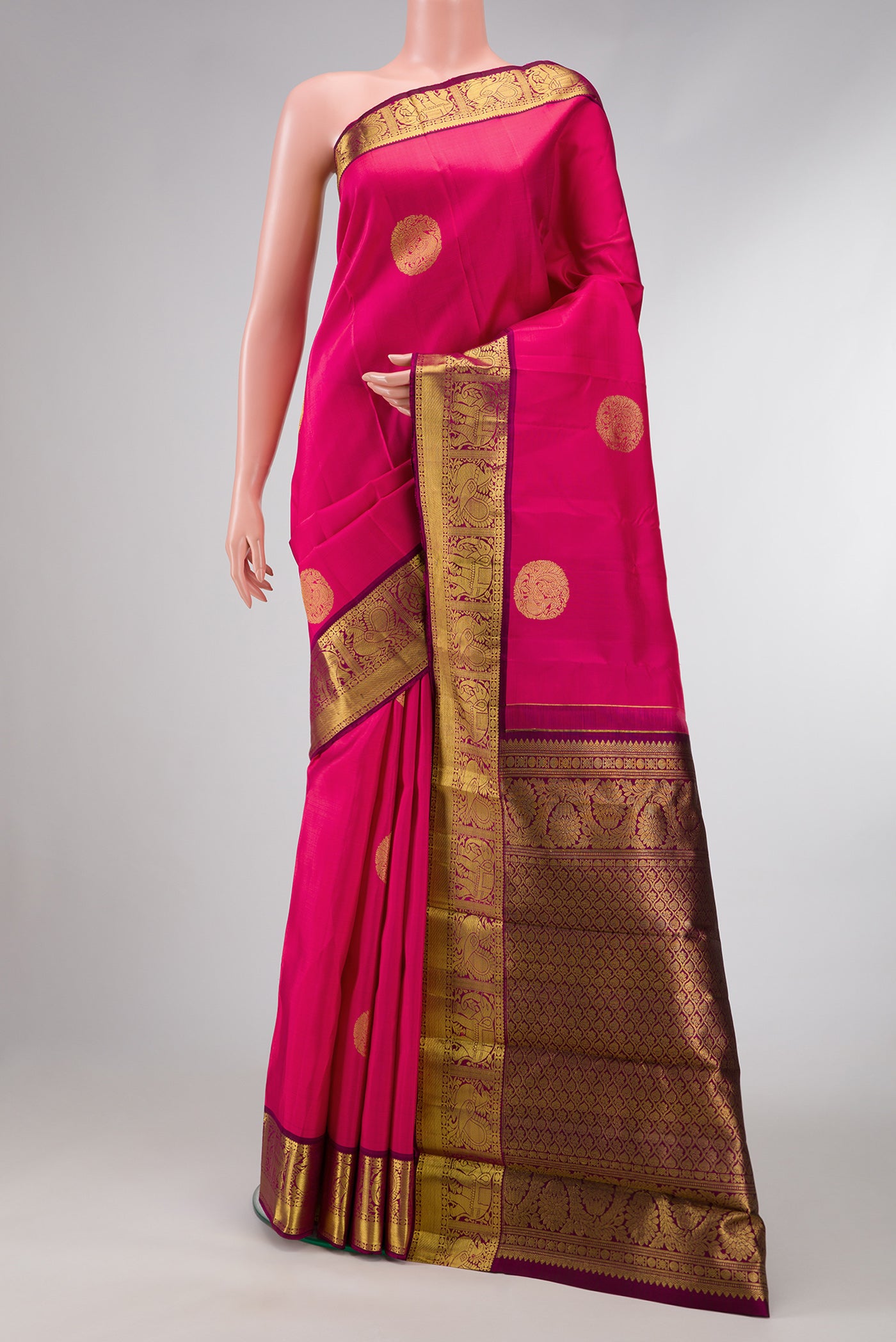 Pink Dual Tone Kanjivaram Silk Saree with Zari Butta on the body and Zari Border.  displayed on a mannequin