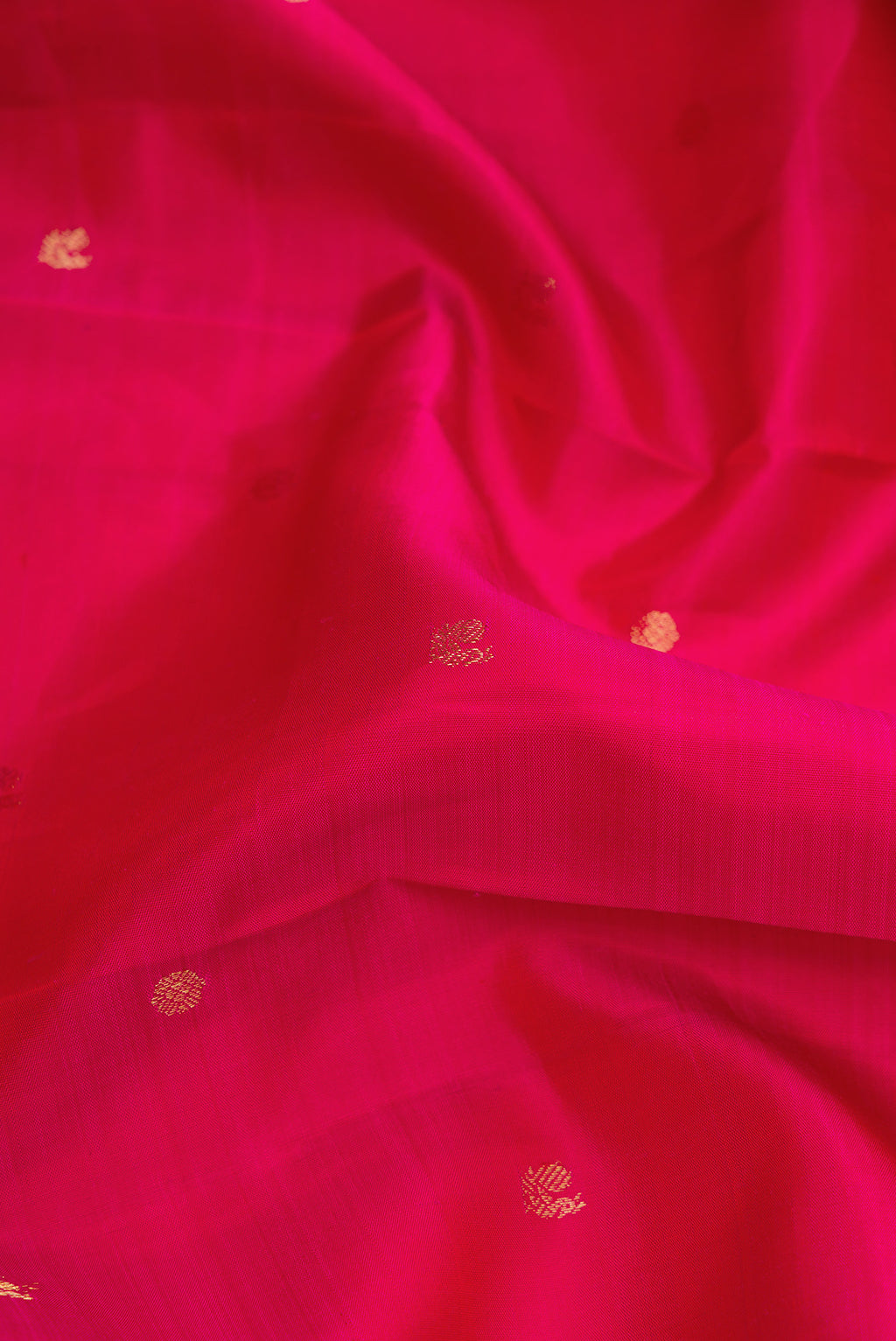 Close up of Pink Dual Tone Kanjivaram Silk Saree with Zari Butta on the body and Zari Border.  displaying folds