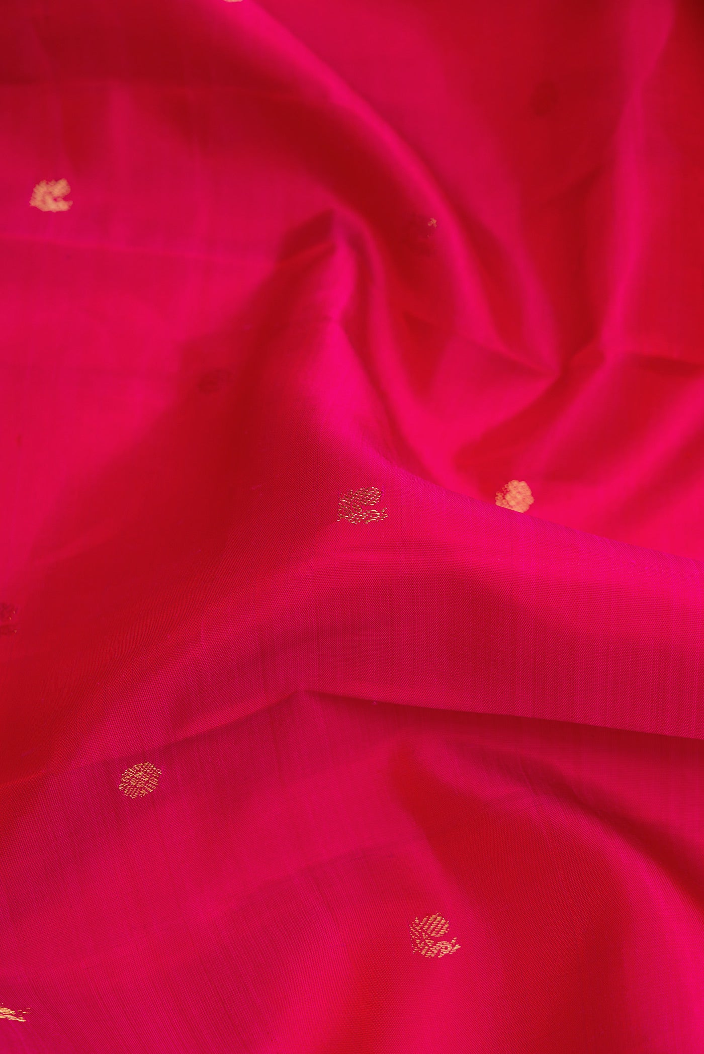 Close up of Pink Dual Tone Kanjivaram Silk Saree with Zari Butta on the body and Zari Border.  displaying folds