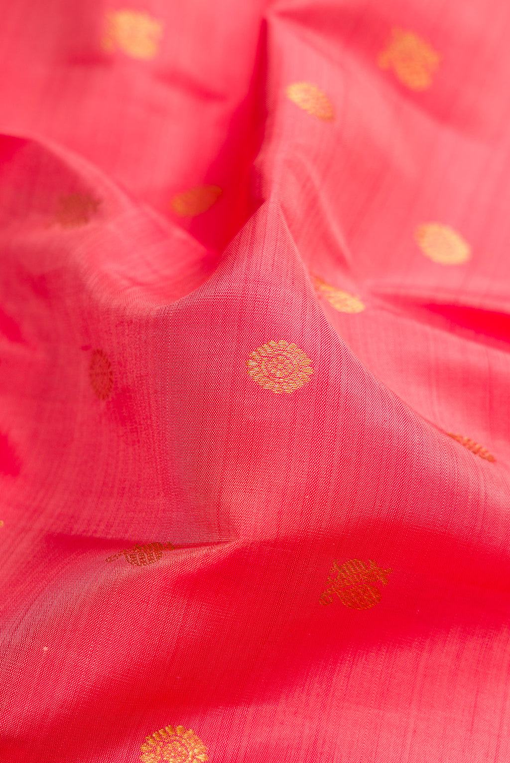 Close up of Pink Kanjivaram Silk Saree with Zari Butta on the body and Zari Border.  displaying folds