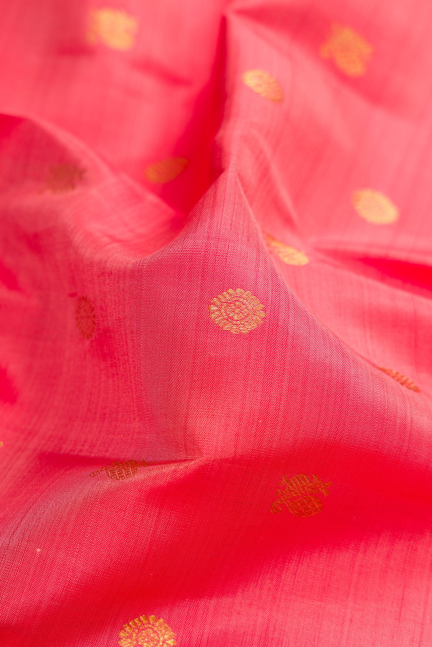 Close up of Pink Kanjivaram Silk Saree with Zari Butta on the body and Zari Border.  displaying folds