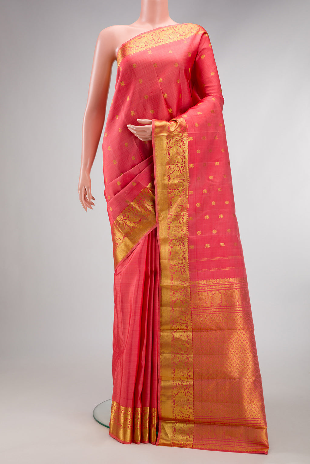 Pink Kanjivaram Silk Saree with Zari Butta on the body and Zari Border.  displayed on a mannequin