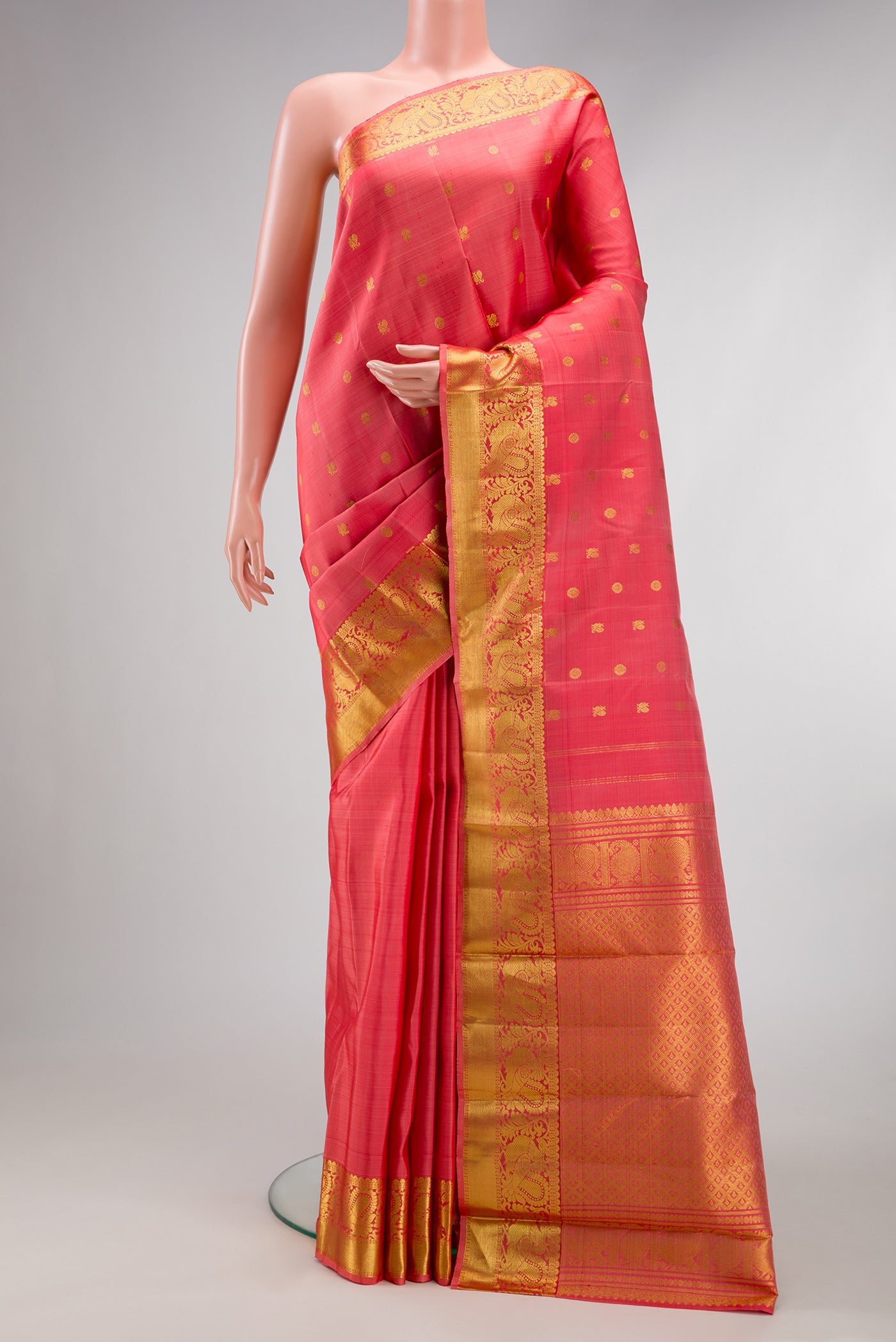 Pink Kanjivaram Silk Saree with Zari Butta on the body and Zari Border.  displayed on a mannequin