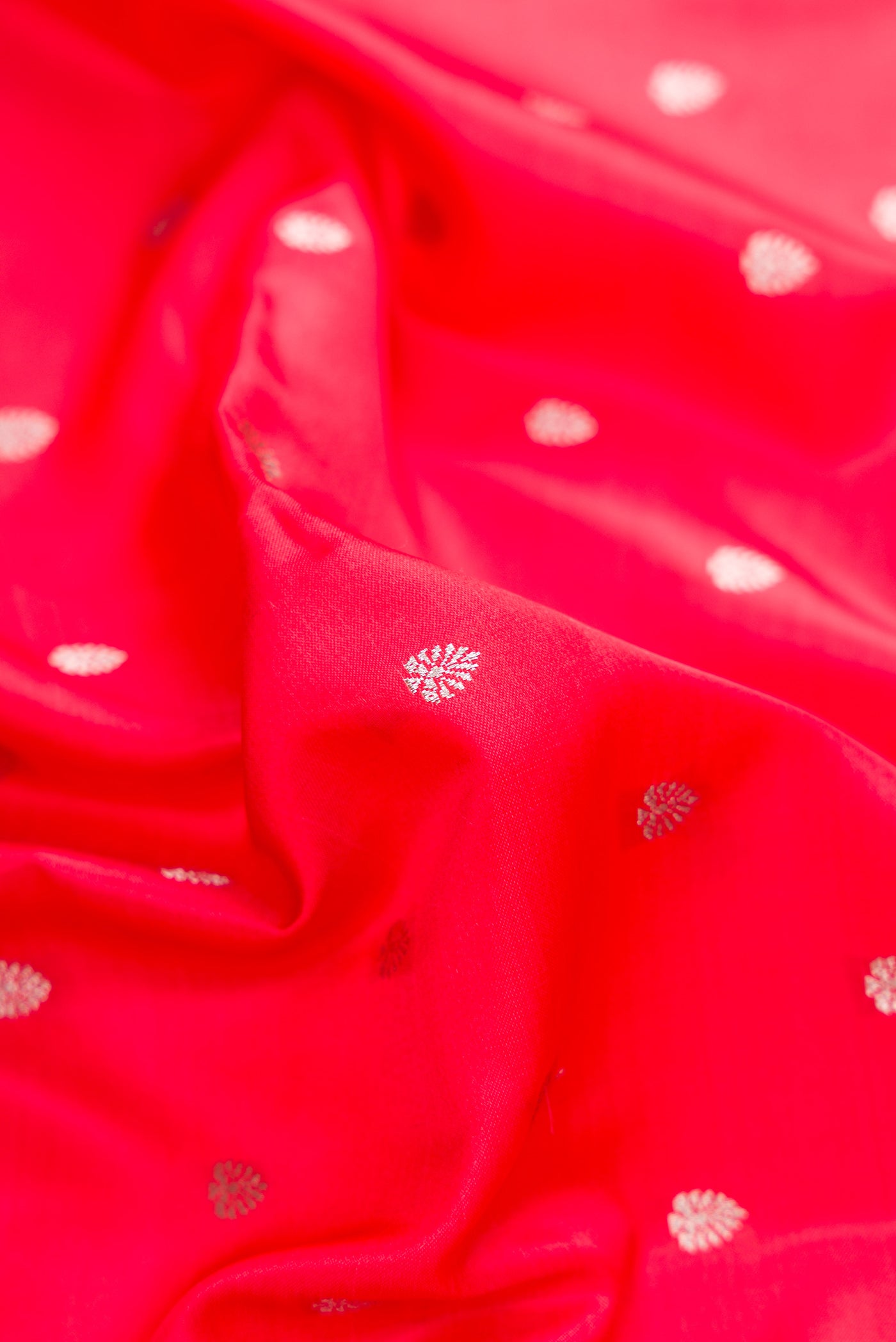 Close up of Dark Pink Dual Tone Banarasi Silk Saree with Zari Butta on the body and Fancy Border.  displaying folds