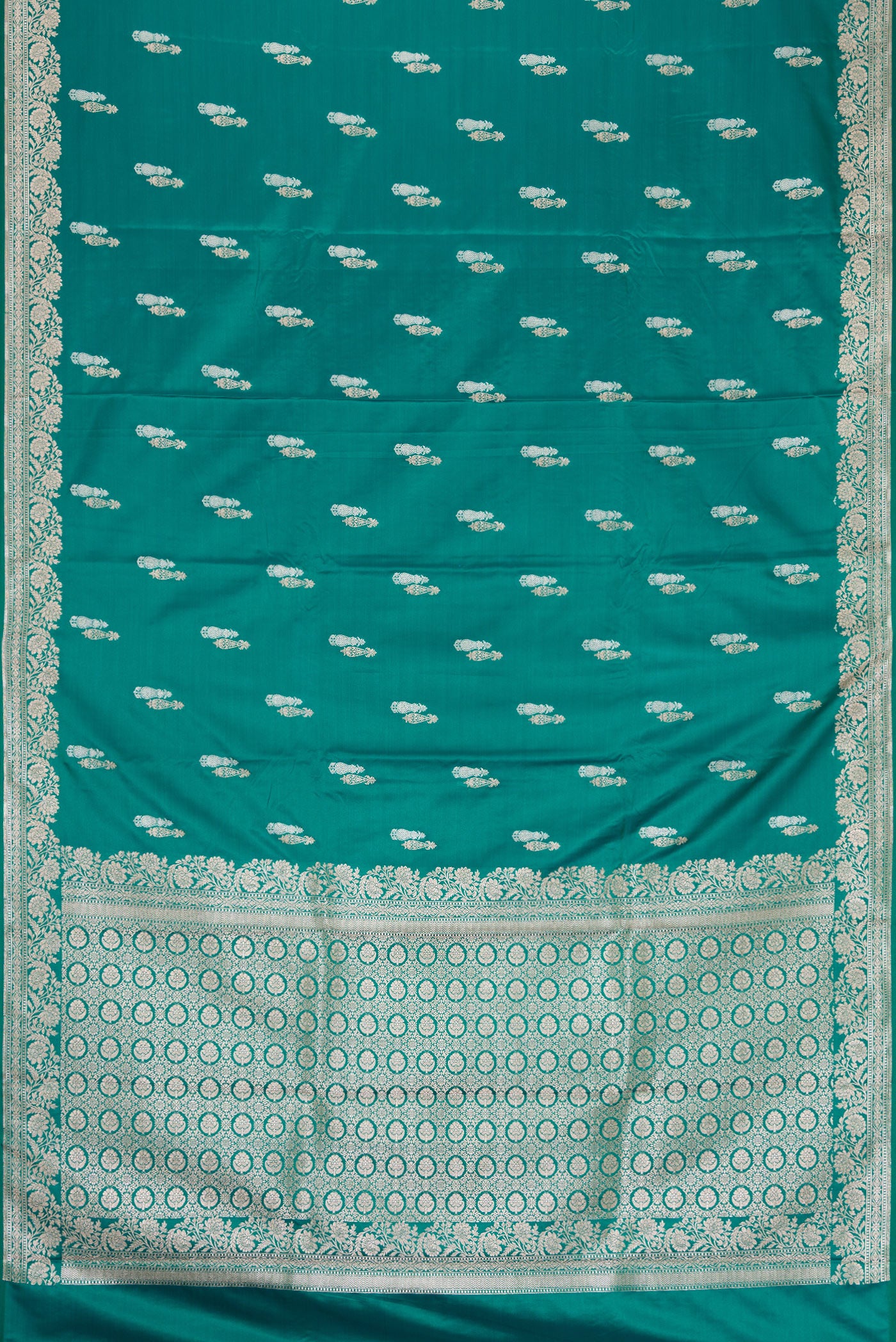 Green Dual Tone Banarasi Silk Saree with Zari Butta on the body and Zari Border.  displayed on a mannequin