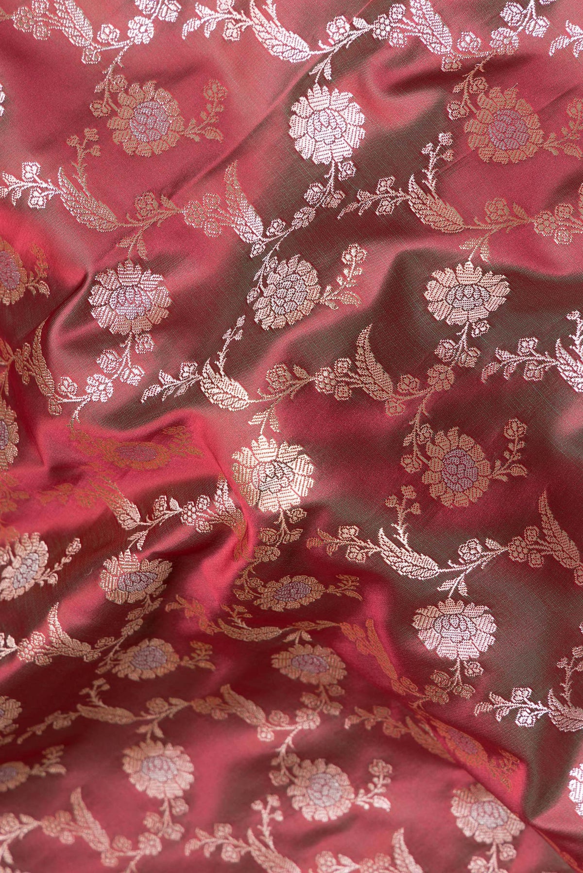 Close up of Green with Red Color Blended Banarasi Silk Saree with Zari Brocade on the body and Zari Border.  displaying folds