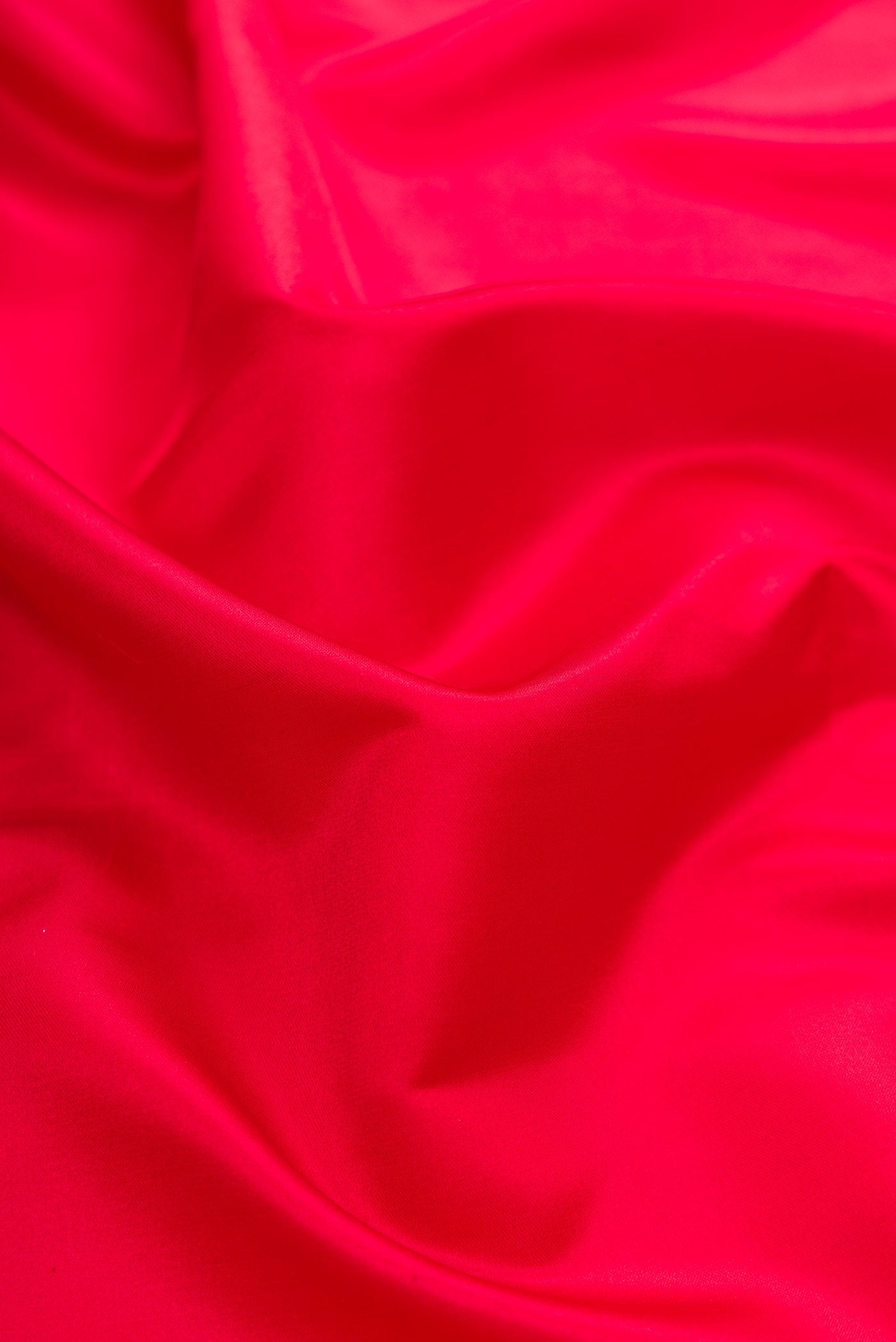 Close up of Red Dual Tone Blended Banarasi Silk Saree with Plain Body and Fancy Border.  displaying folds